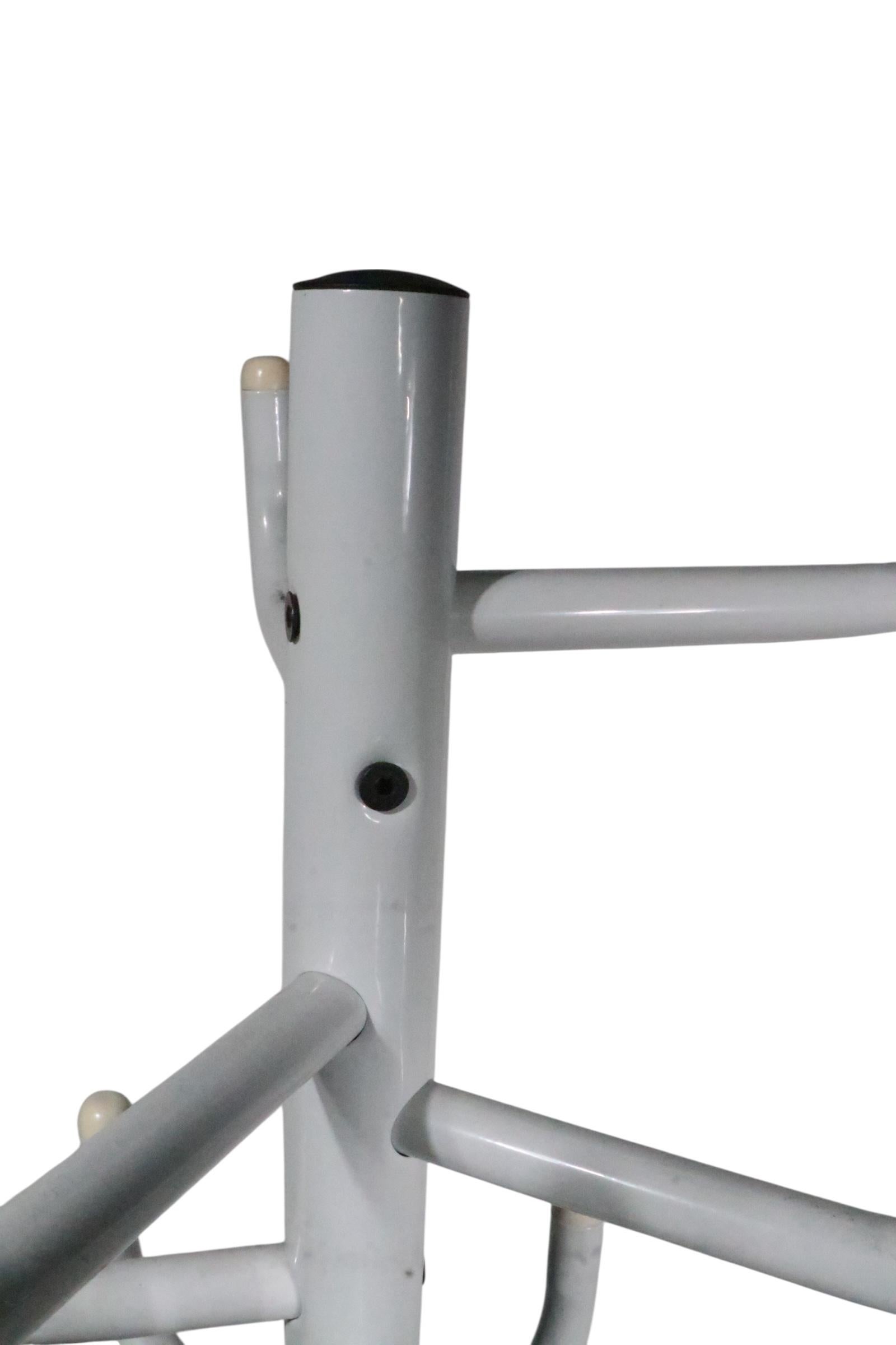 Classic 1980's post - modern design made in Sweden by Ikea. This piece was designed by Rutgers Andersson, it features 8 hooks at the top, a center pole, and three legs. Solid, sturdy, clean and ready to use condition.
 W at top 14