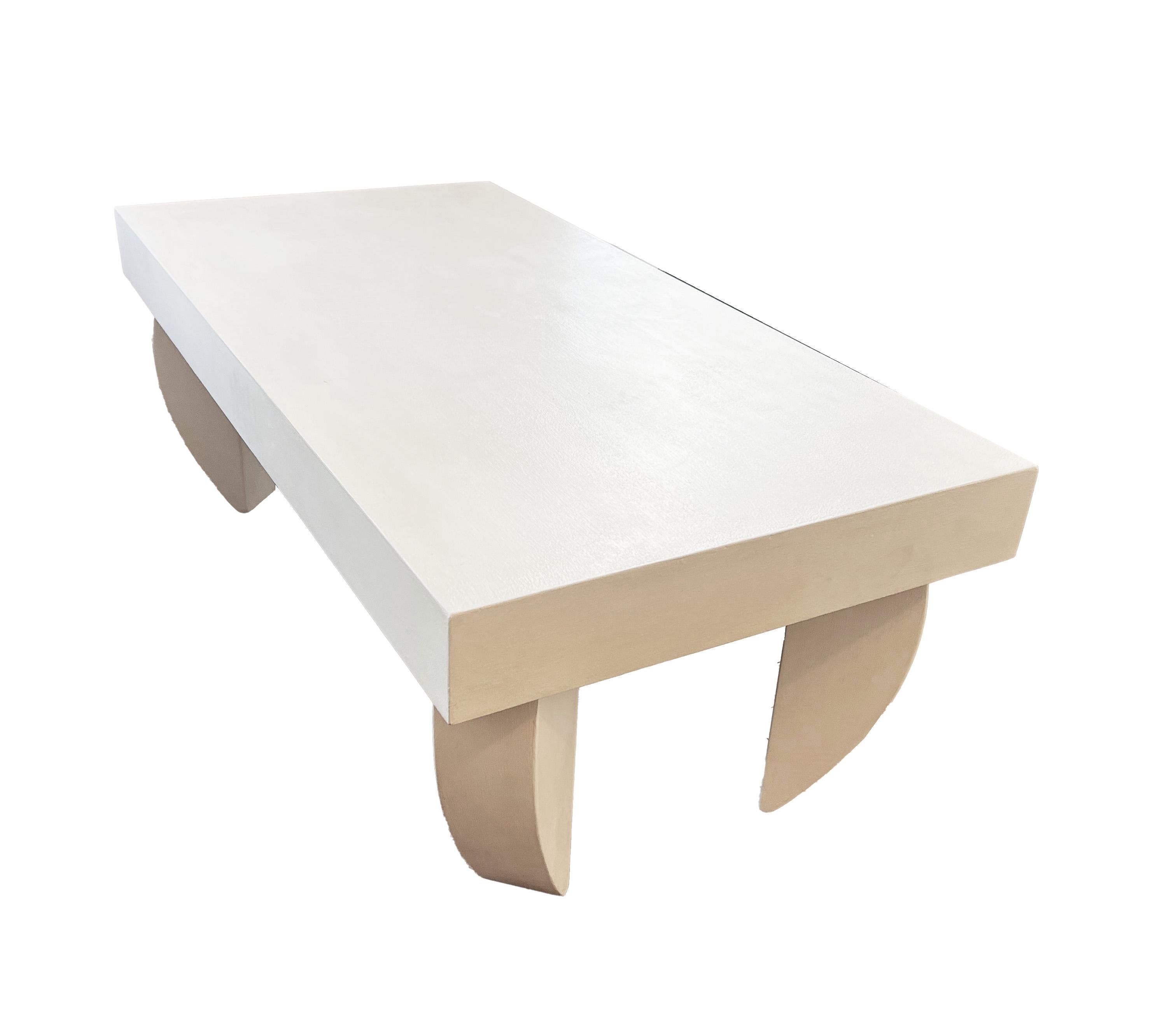 Add a touch of postmodern elegance to your living space with this exquisite coffee table, meticulously crafted by the skilled hands of Rob Anderson. This stunning piece boasts a custom H. Ryan Studio white paint and wax finish, enhancing its sleek
