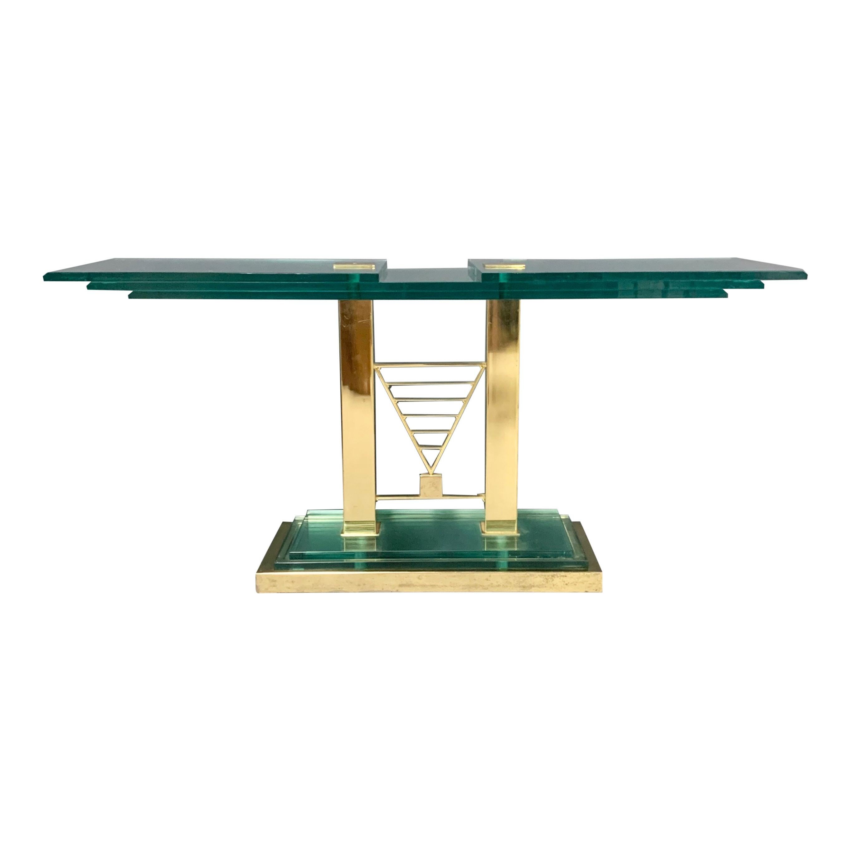 Postmodern console table, constructed of multi layered green tinted glass and brass circa 1990s, in the style of Fontana Arte. This piece is a stunner! The dimensions are 59.5