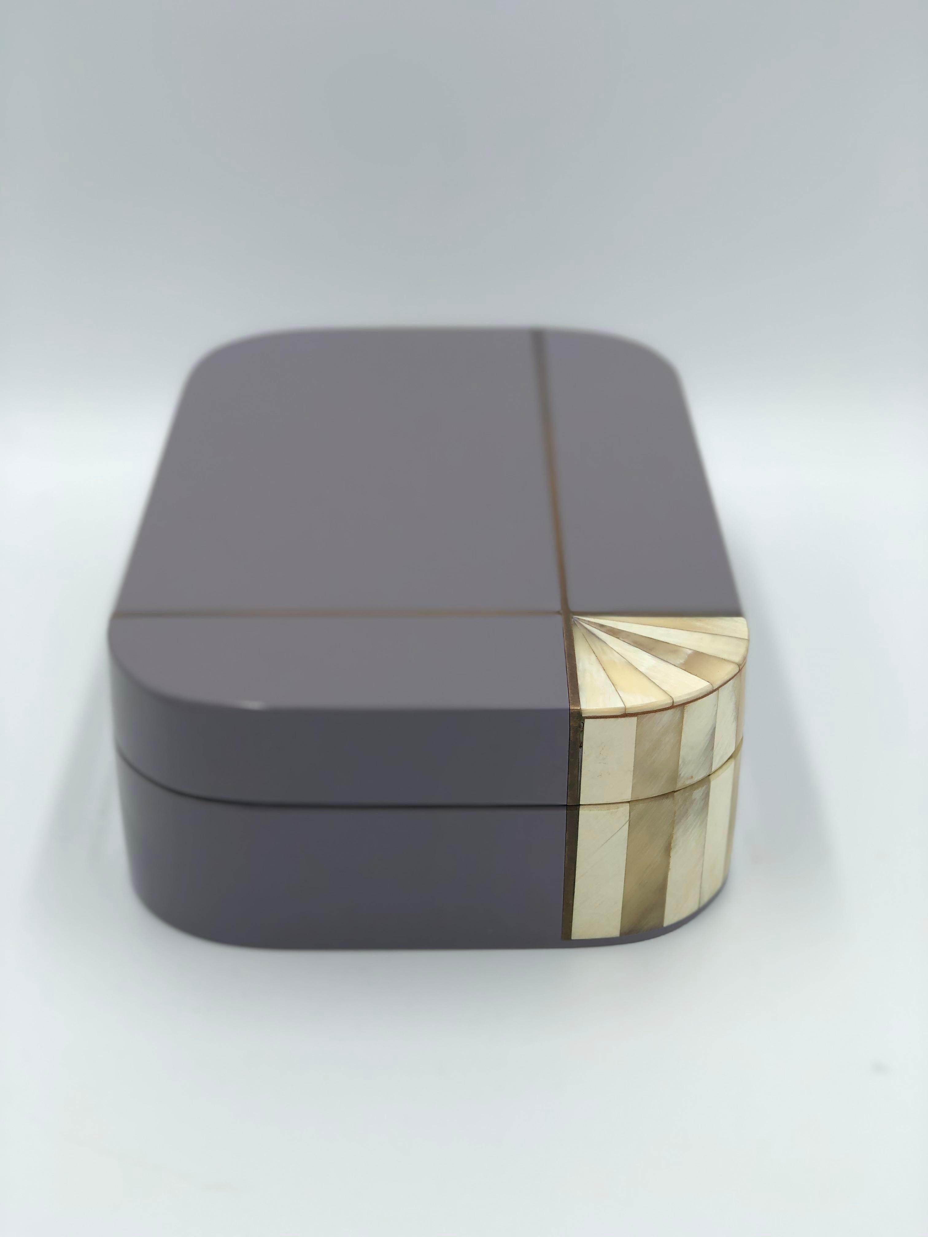 Stunning Lacquer Lidded Box made in Italy. Lavender lacquer offset with Brass Piping and Bone corner detail.
Wood lined with a tight fit.

Matching picture frame listed separately.