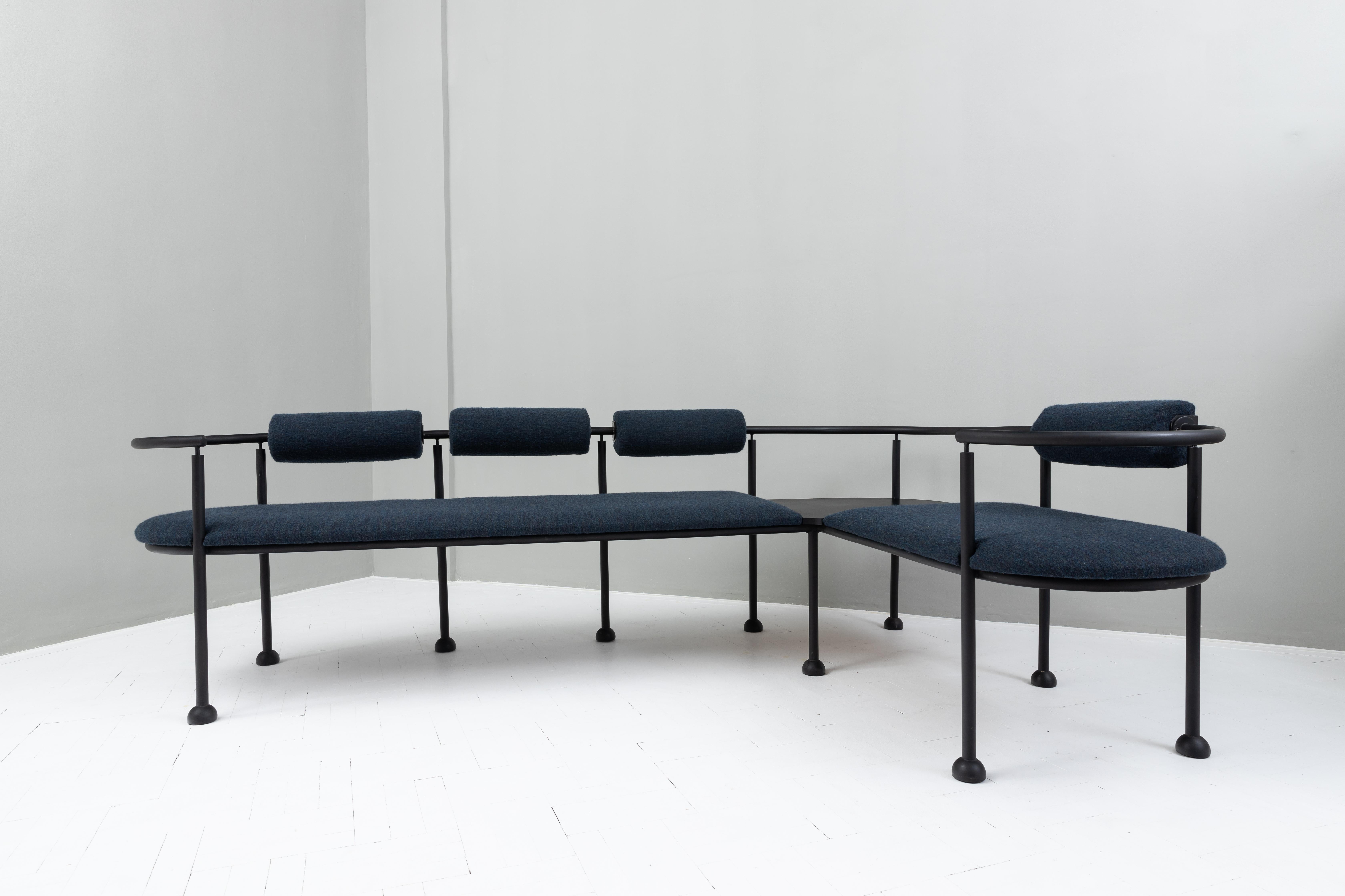 The postmodern corner bench was designed in the 1980s. It's made of a black metal structure, with a bench seat and back upholstery.

Unknown designer
