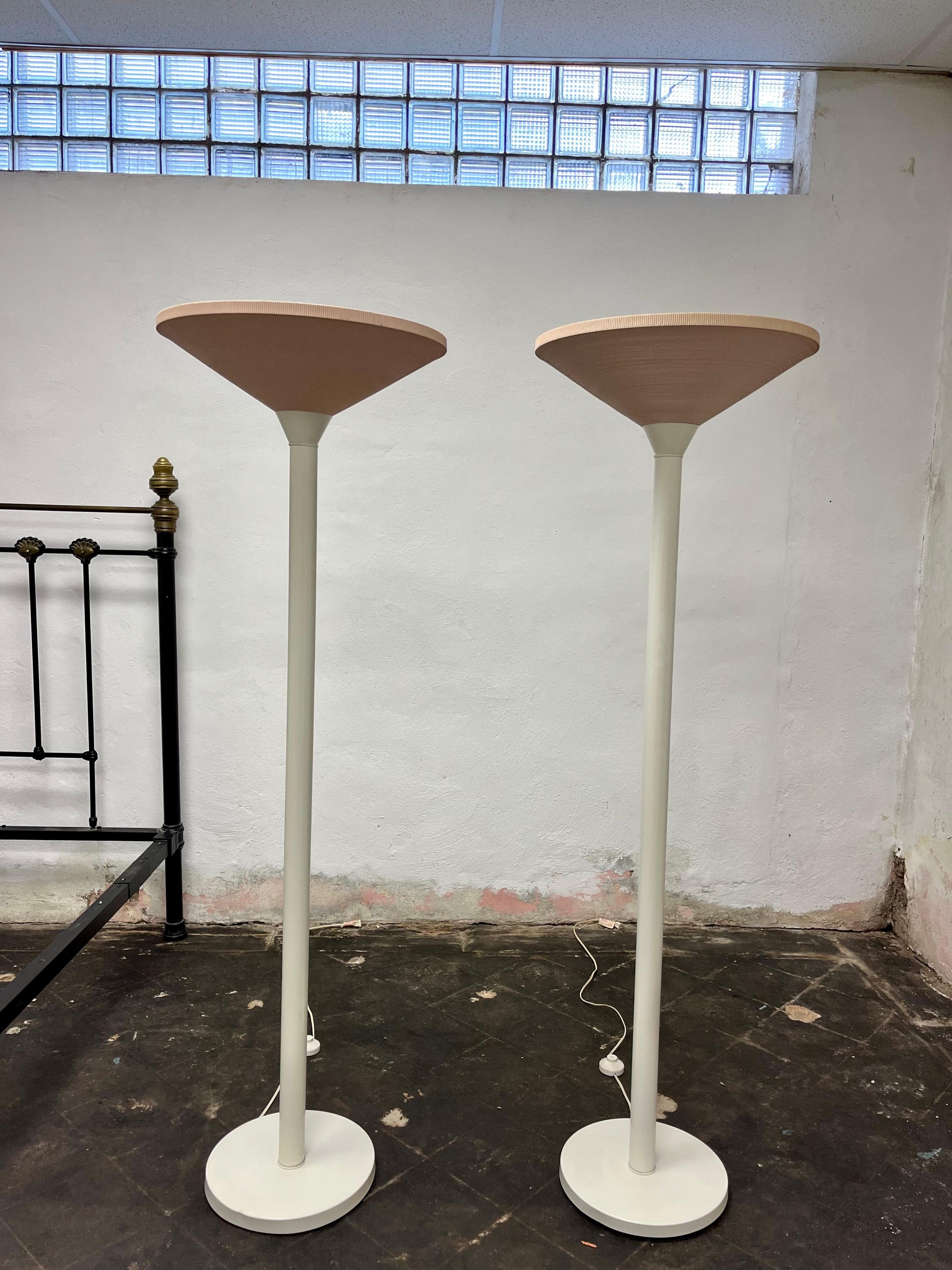 Spectacular example of Postmodern design. White metal floor lamps or torchieres with Corrugated Cardboard shade in a soft pink color. Time warp pieces. Great casting when lit offering subtle lighting. As close to perfect condition with one small