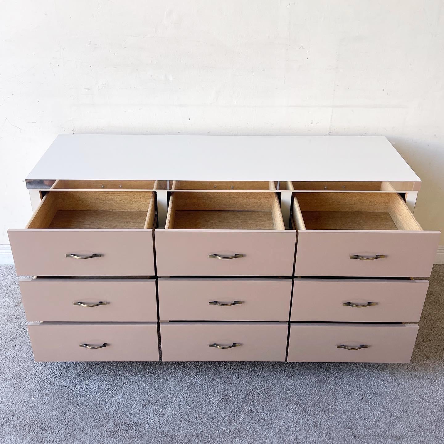 Amazing vintage postmodern triple dresser. Features a cream and taupe lacquer laminate with a chrome strip bordering the top.

Additional information:
Materials: Wood
Color: Cream, Taupe
Style: Postmodern
Time Period: 1980s
Place of Origin: