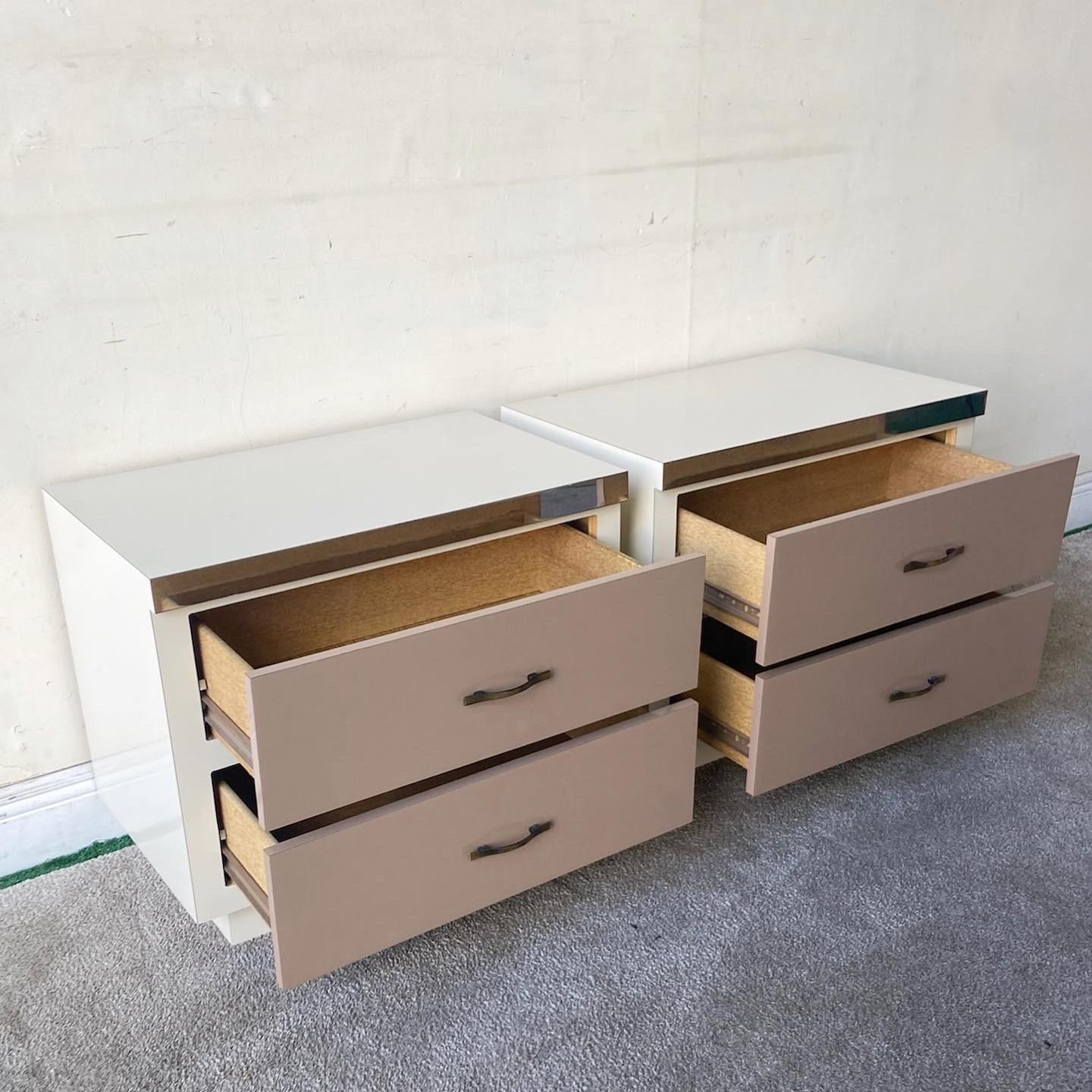 Exceptional pair of postmodern nighstands. Each feature a cream lacquer laminate with taupe lacquer laminate drawer faces with a chrome panne at the top.