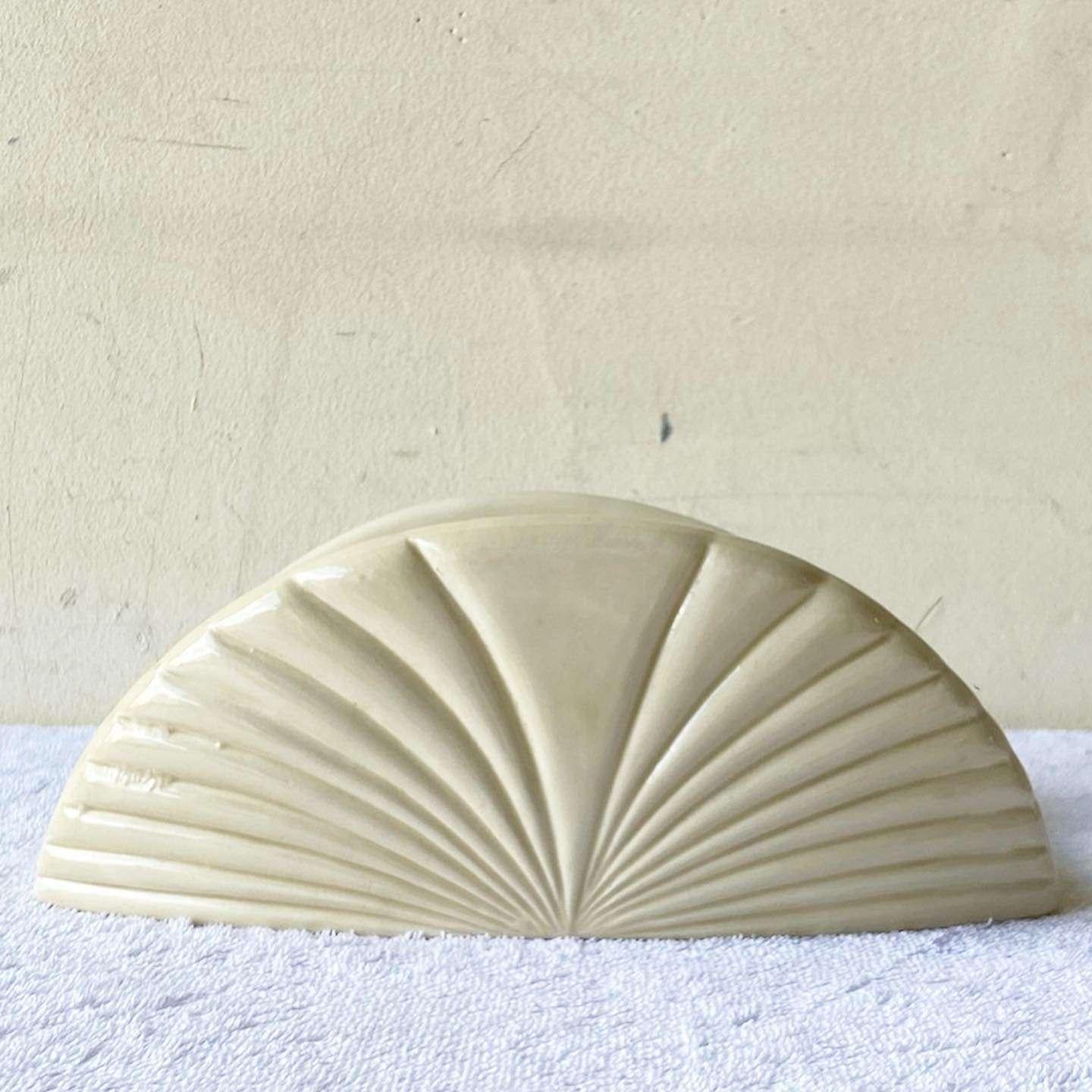 Amazing vintage postmodern ceramic napkin holder. Features a scalloped design with a cream finish.