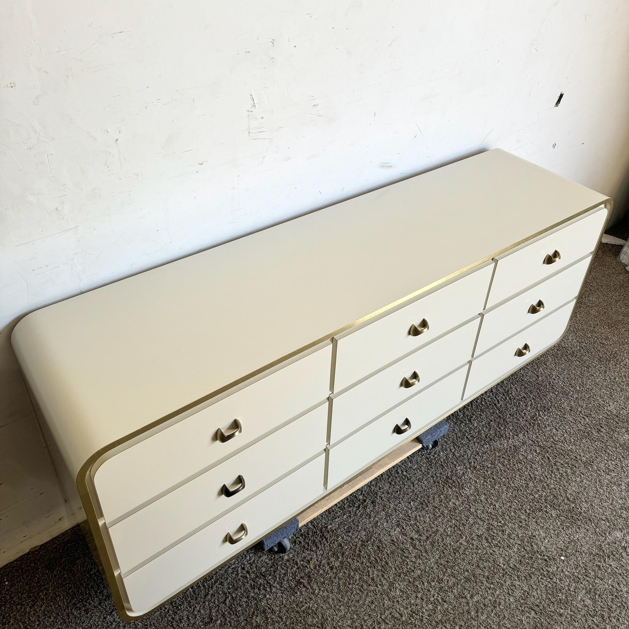 Late 20th Century Postmodern Cream Lacquer Laminate Waterfall Dresser With Gold Accents