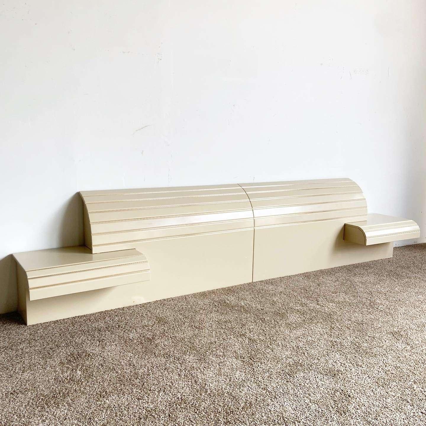 Exceptional vintage postmodern waterfall king size headboard with floating waterfall nightstands by Rougier. Features a cream lacquer with gold accents.

78.5” width between nightstands
Headboard measures 10” deep
Each nightstand measures 28” wide