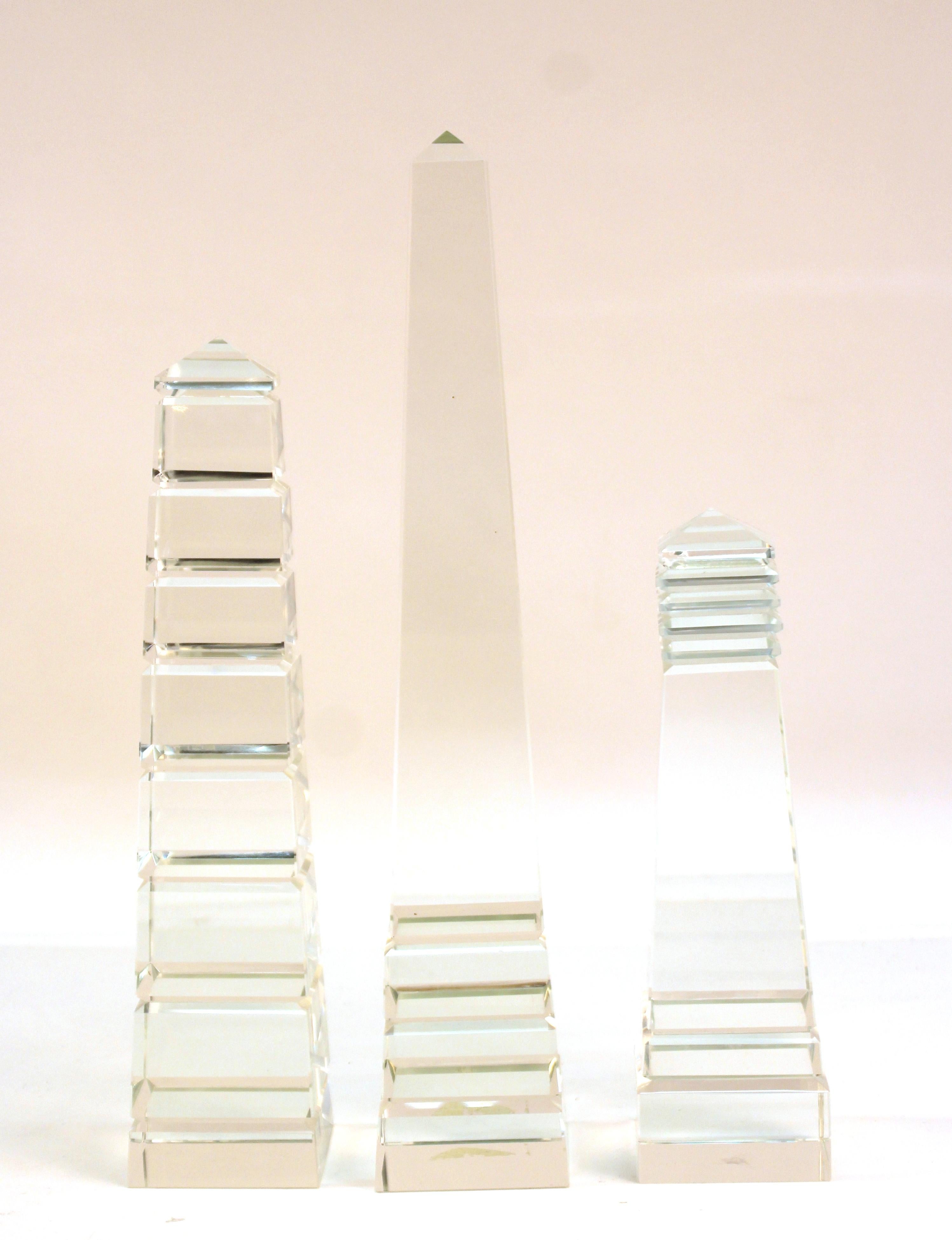 Postmodernist set of three heavy glass crystal obelisks, made in the United States during the 1990s. The set is in good vintage condition, with a chip to one of the upper corners of one of the obelisks.