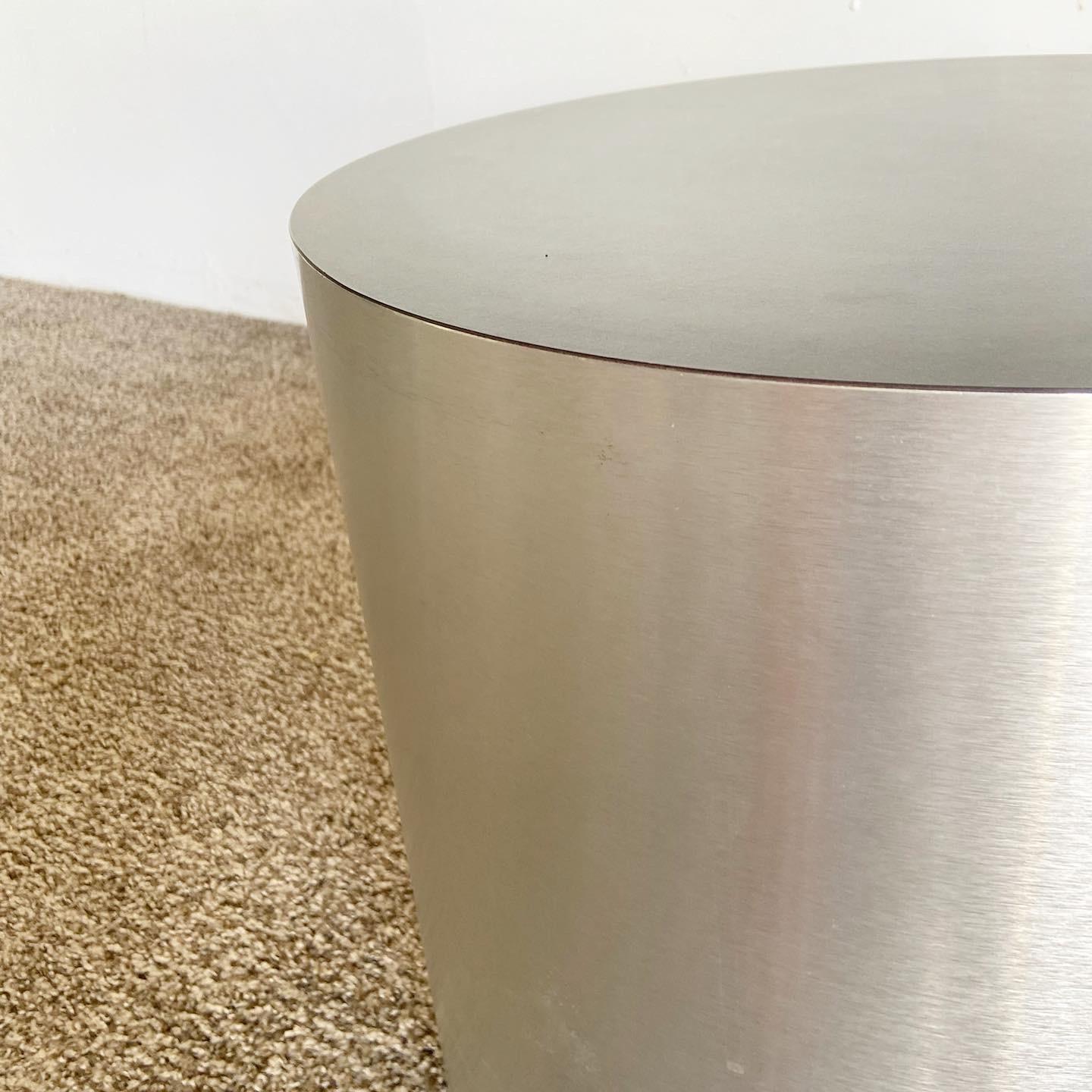 Exceptional vintage postmodern cylindrical drum side tables. Each feature a brushed steel laminate around the sides and a black matte laminate top.