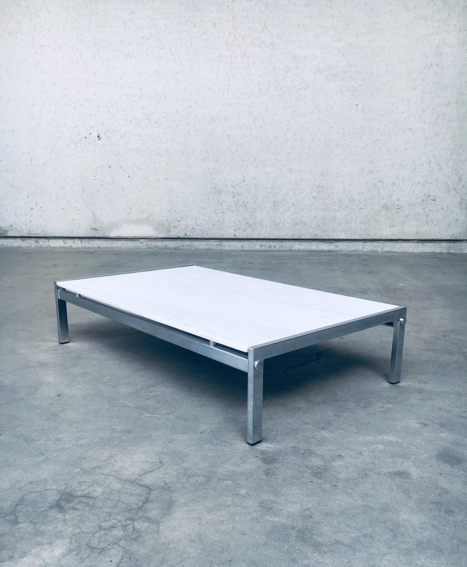 Vintage Postmodern Italian Design Low Coffee Table in Carrara Marble, made in Italy 1970's. Chrome metal base with carrara marble top. Sleek Minimalist in design. In very good original condition. Measures 26cm x 116cm x 68cm.
