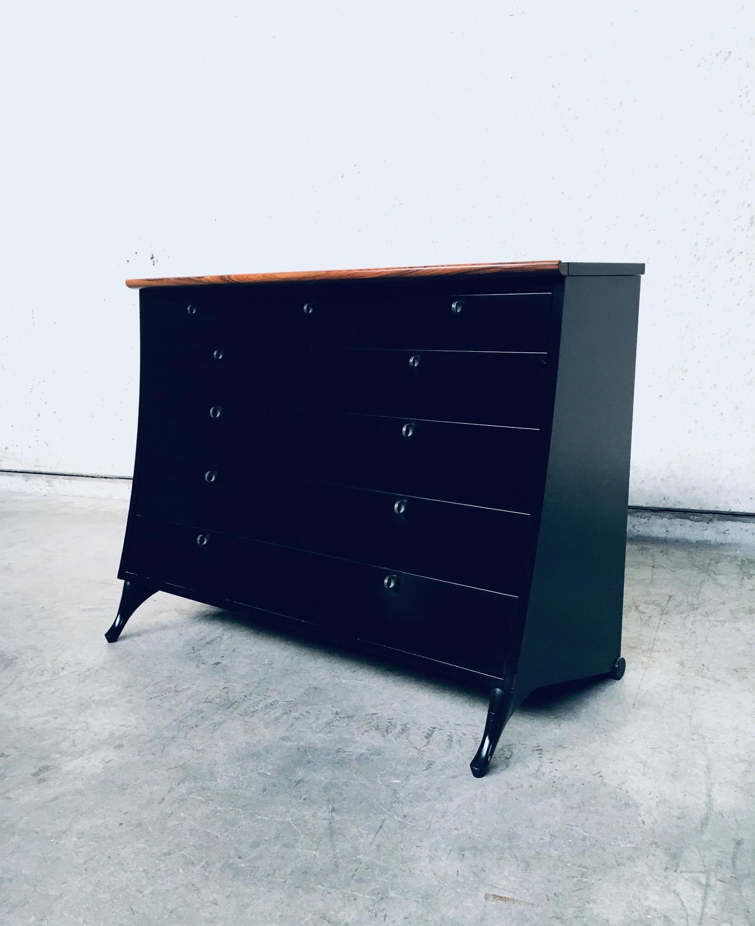 Postmodern Modern Design Chest of drawers by Umberto Asnago for Giorgetti, made in Italy 1980's. Rare chest of drawers / commode. Black laquered wood with palissander trim on front top. Beautifull slanted design which seems to flow at the front. 3