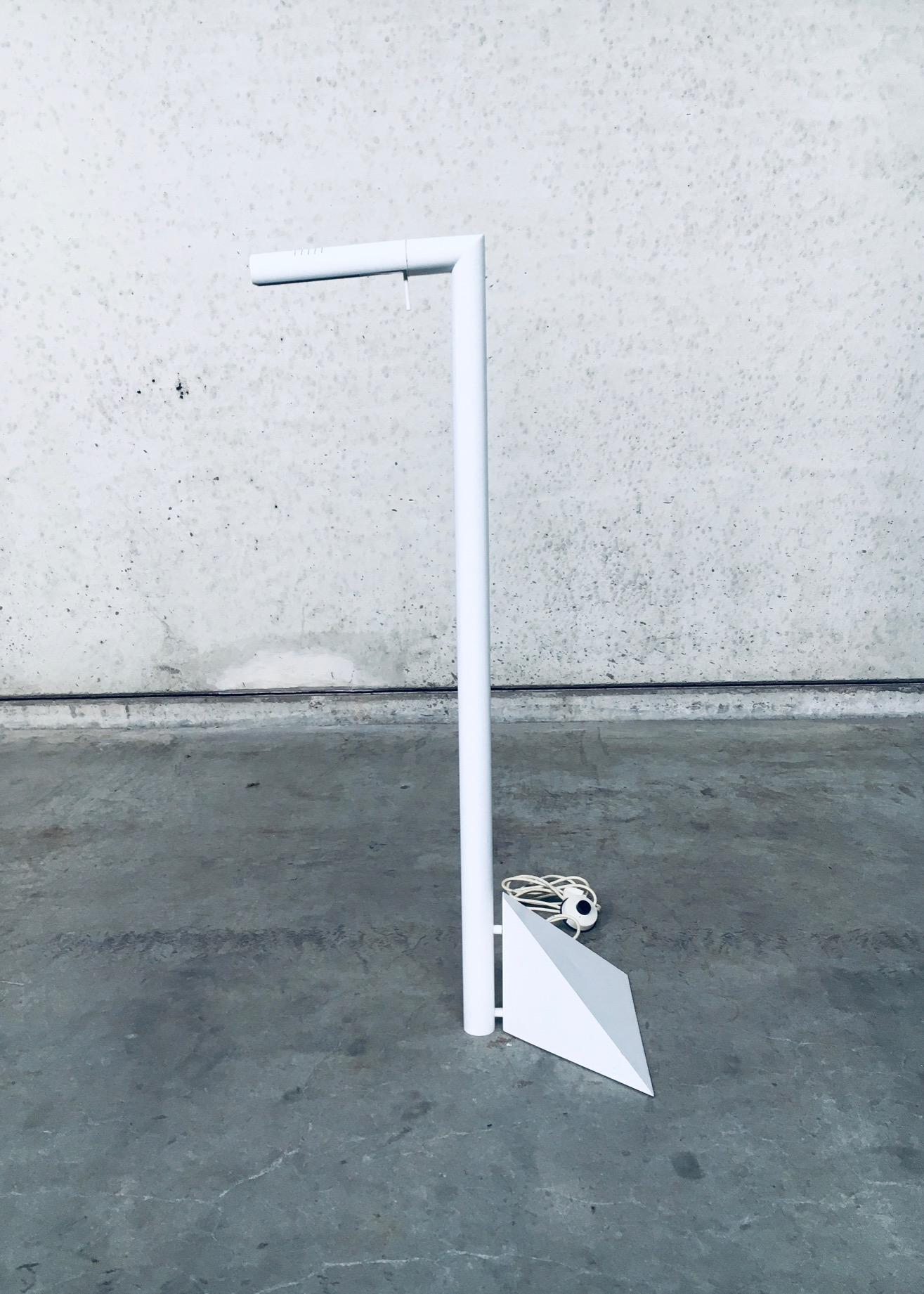 Vintage Postmodern Design Floor Lamp, made in Italy 1980's. White laquered metal construction with adjustable light. In very good, all original condition. Architectural in design. The light can be turned up, down or sideways. Measures 50cm x 109cm x