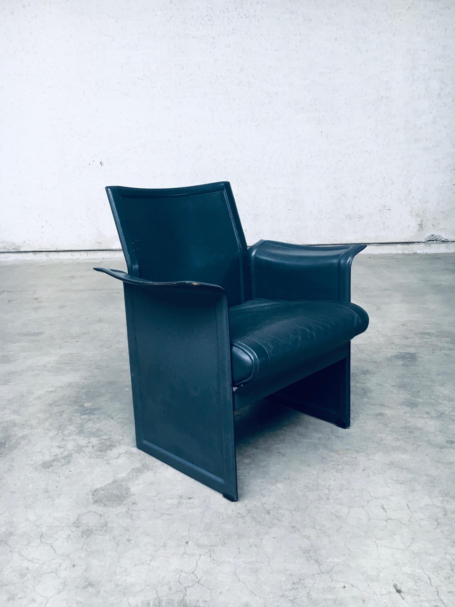 Vintage Postmodern Design KORIUM KM1 Leather Arm Chair by Tito Agnoli for Matteo Grassi. Made in Italy, 1980's period. All dark blue grey leather armchair. Very comfortable lounge chair timeless design model. This is marked and labeled. This comes