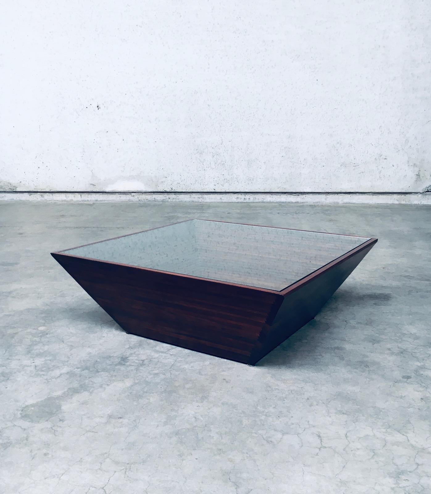 Postmodern Design 'Reverse Pyramid' Square Coffee Table. Made in the 1980's. Wood reverse pyramid shape with steps on the inside. Black glass on the bottom and clear glass on top. A well executed and designed coffee table. Minimalist and