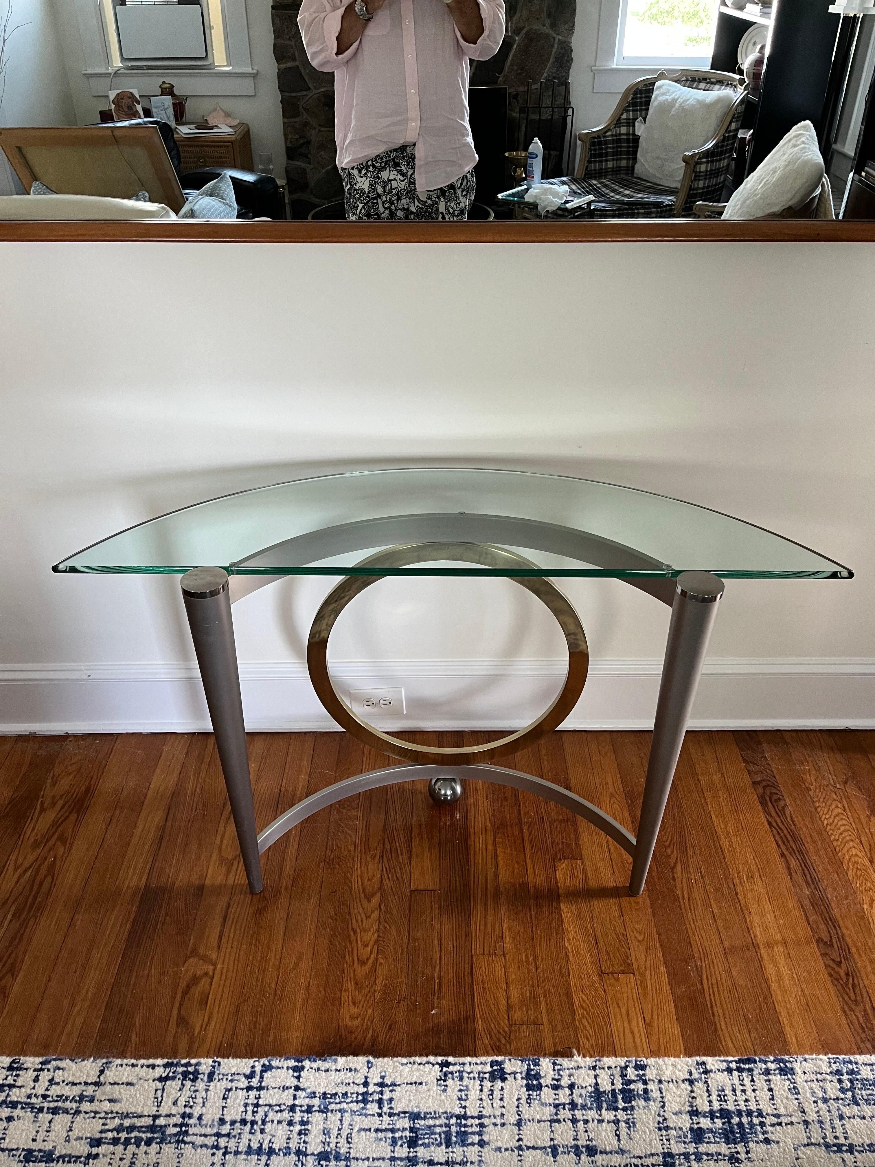 Great postmodern demilune console in the styling of DIA. Brushed steel offset with complimenting polished brass ring. Tapered legs and awesome ball support. Thick glass with no chips or cracks.
Curbside to NYC/Philly $350