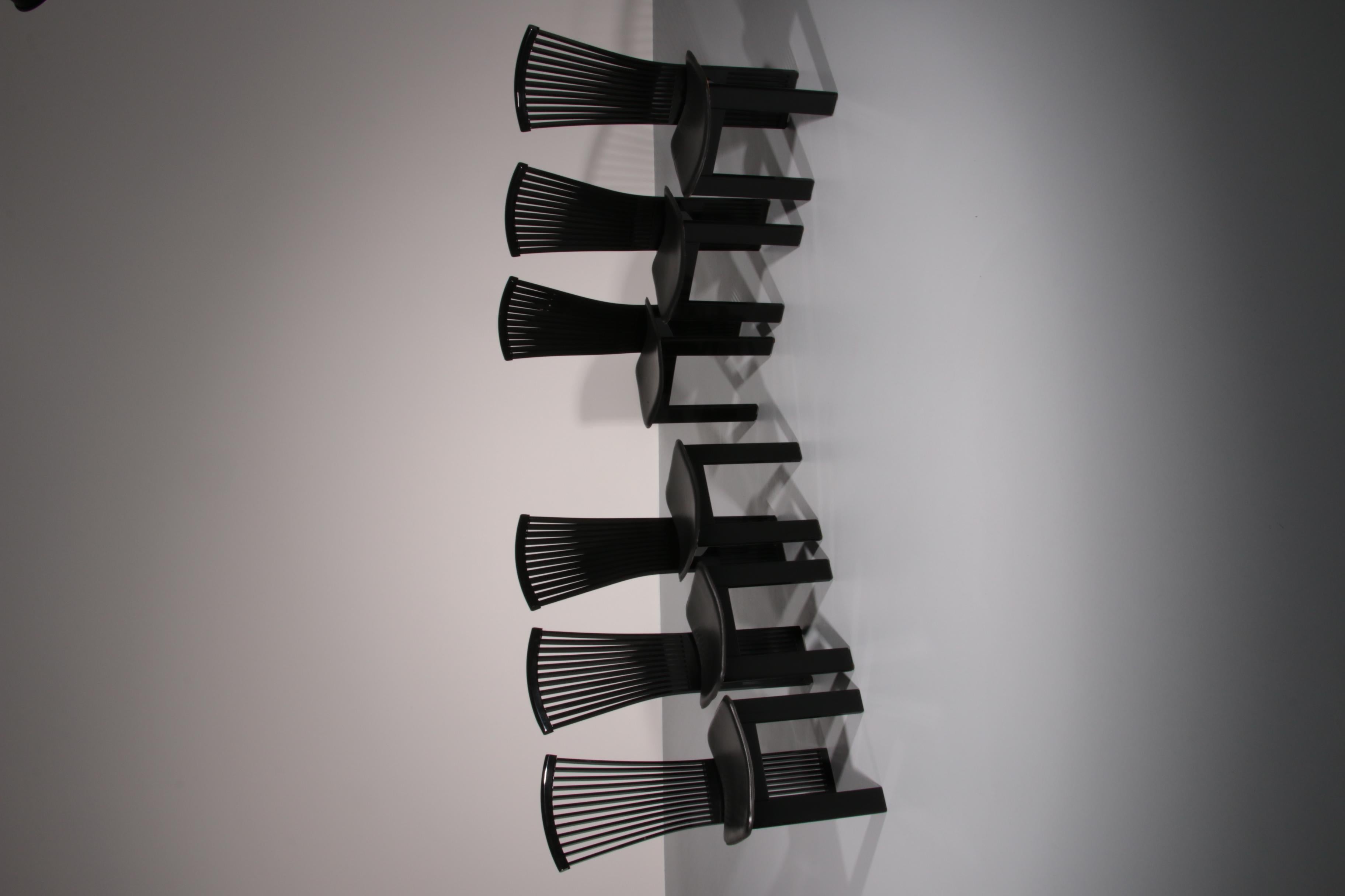 n elegant set of 6 sleek Italian dining chairs by Pietro Costantini. They’re a real example of the bold creativity of 1980s postmodern design. The chairs feature a distinctive silhouette with high, fan-shaped backrests, composed of neatly arranged