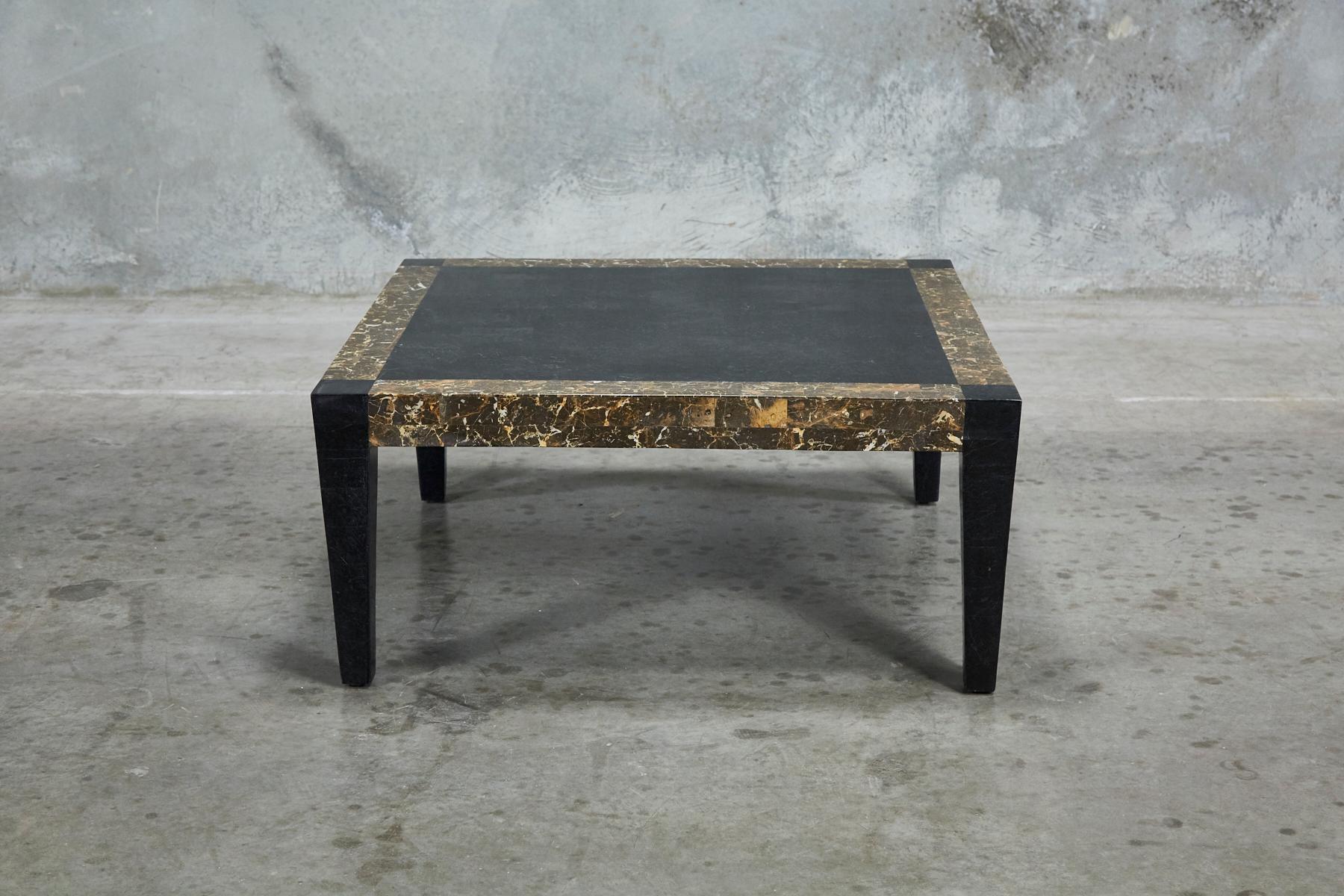 Simple and elegant modern form completely covered in tessellated stone over a fiberglass body. Legs and center of tabletop executed in black stone, snakeskin stone detail surrounds the edges.

All furnishings are made from 100% natural Fossil Stone