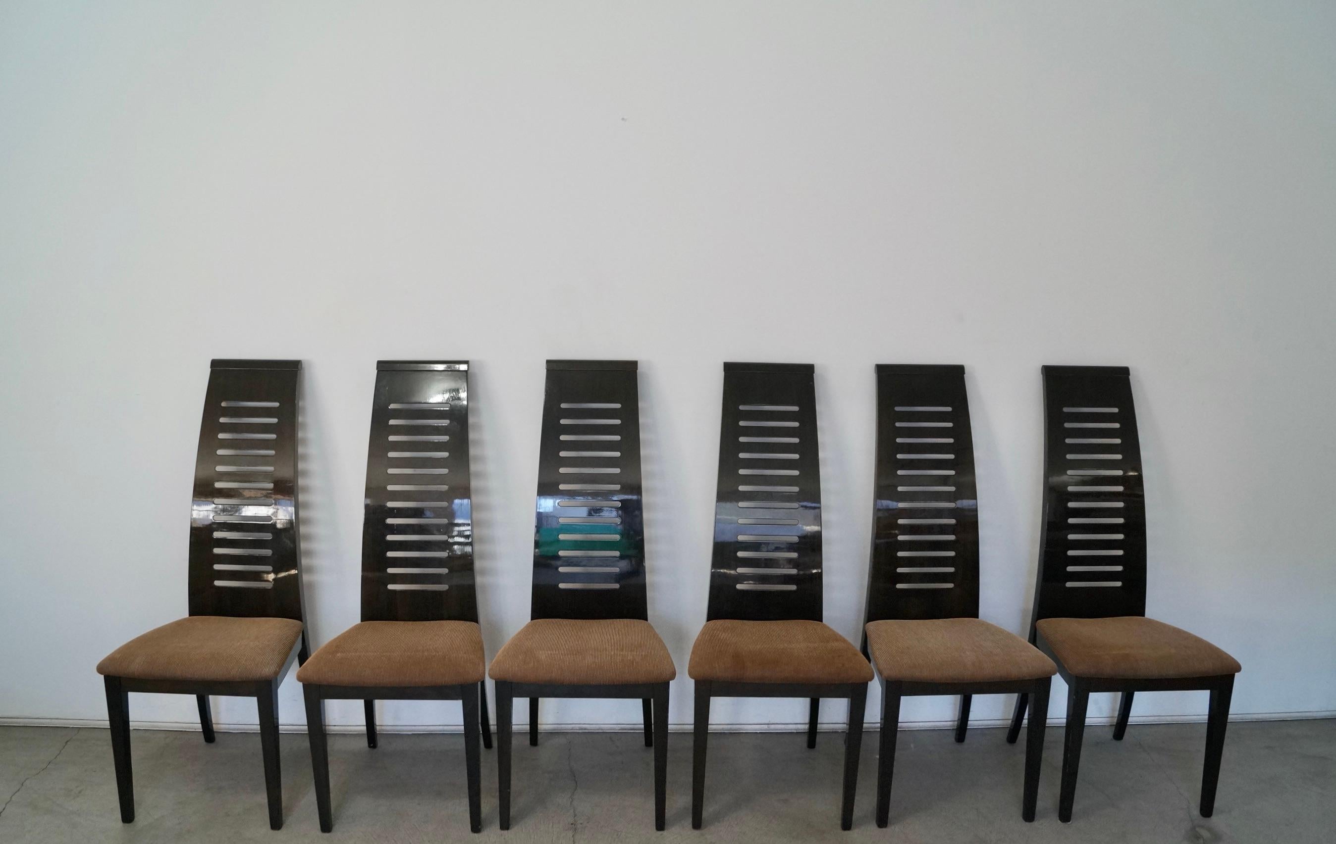 Vintage late 1990's / early 2000's six dining chairs for sale. Designed by Pietro Costantini for Ello Furniture, and manufactured in Italy. They are very solid and well built chairs, and are lacquered. They have a solid dark wood frame, and have the