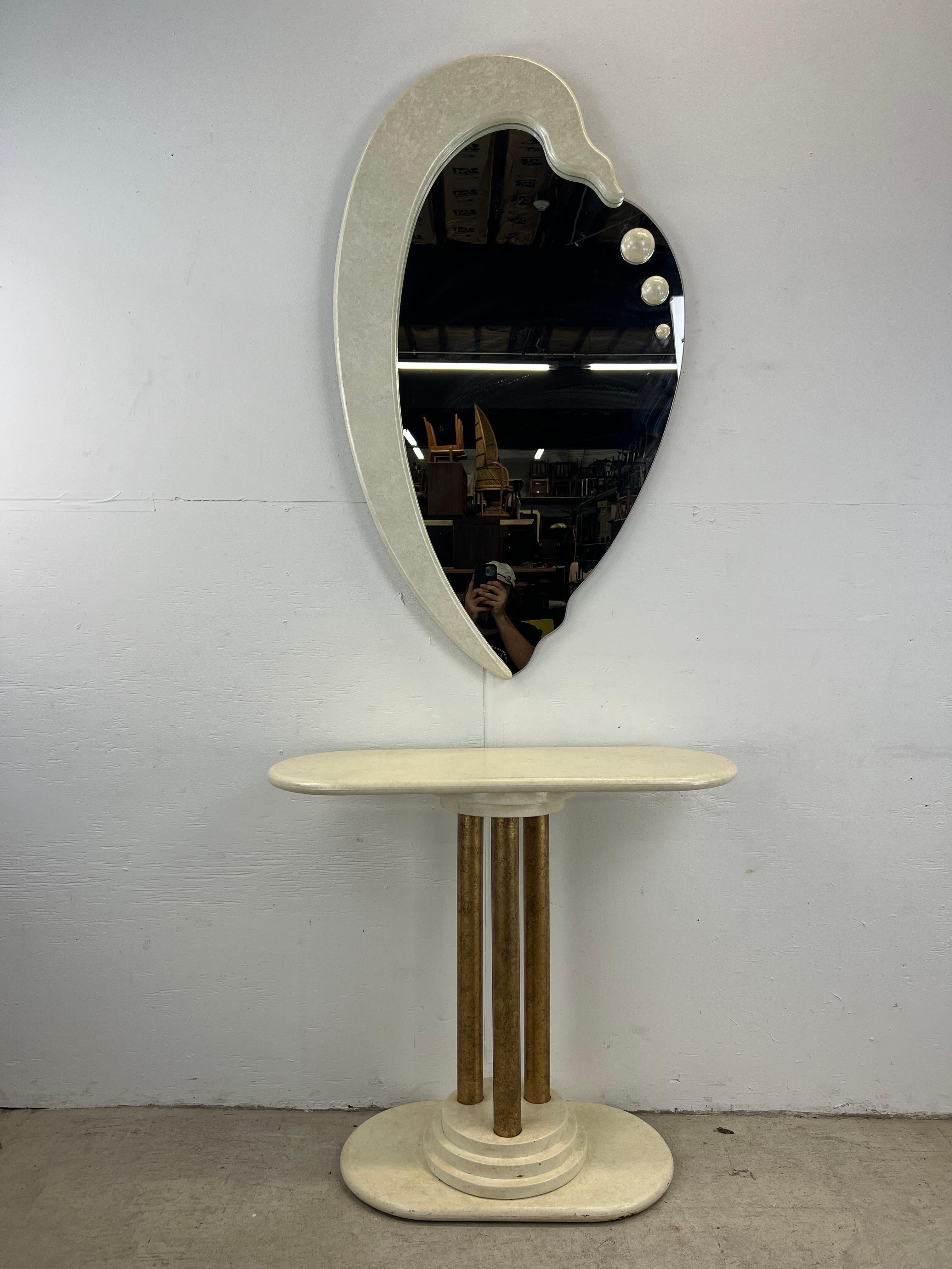This vintage postmodern mirror & pedestal set features unique shaped mirror with three dimensional details and a white lacquer pedestal with brass accented posts and step base.

Mirror Dimensions: 26.5w 2.5d 46h
Pedestal Dimensions: 33w 12d