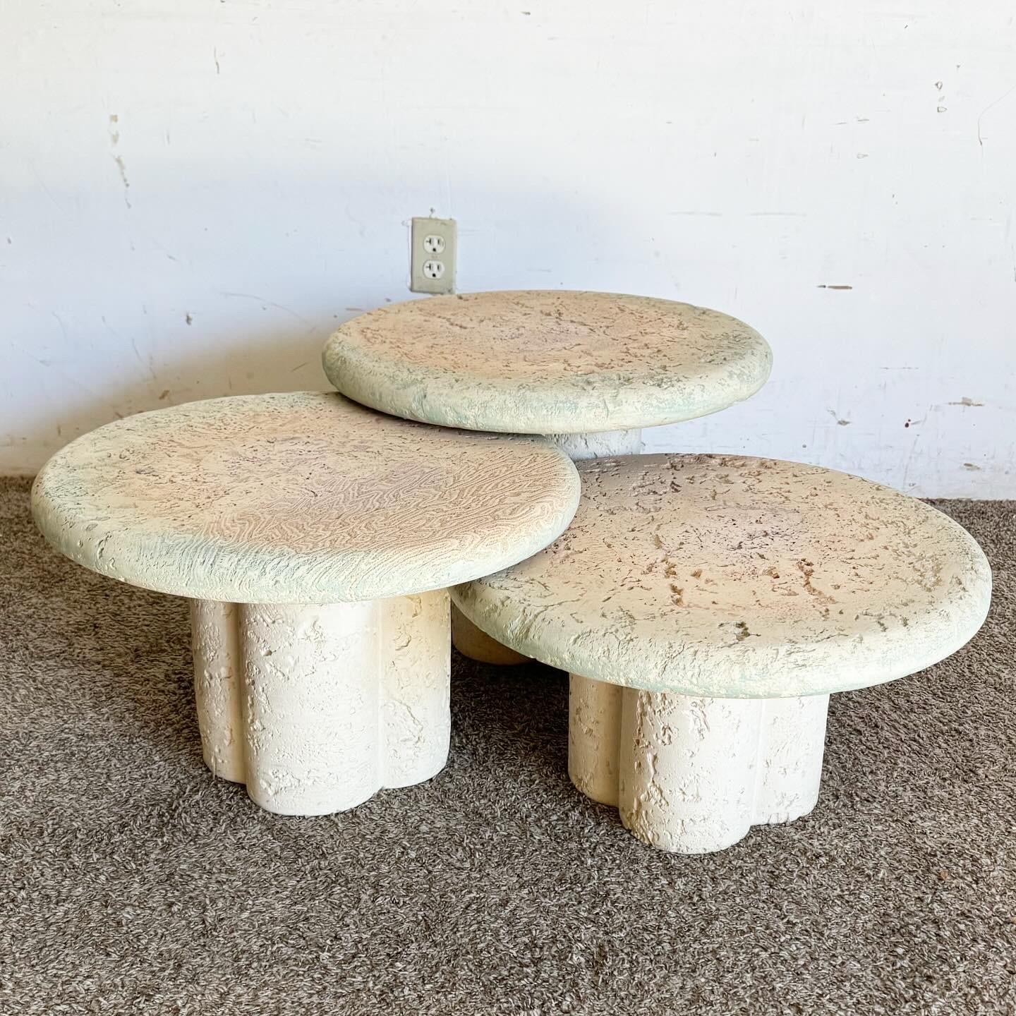 Discover the whimsical charm of the Postmodern Faux Coquina Coral Mushroom Nesting Tables. Crafted to resemble mushrooms, these tables blend artistic flair with practicality, offering a unique, space-saving solution for modern interiors. Their
