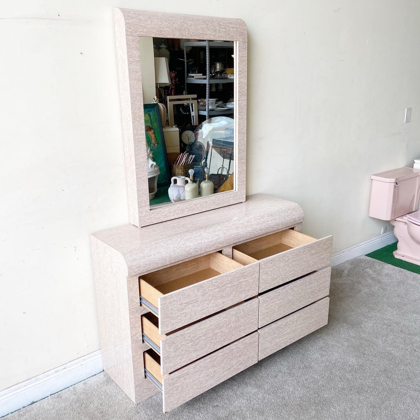 Amazing 1980s postmodern waterfall dresser with matching mirror. Features a tan/beige faux marble laminate with 6 spacious drawers.

Dresser measures 48” W, 15.5” D, 
Mirror measures: 30.25” W, 4” D, 42.5” H.