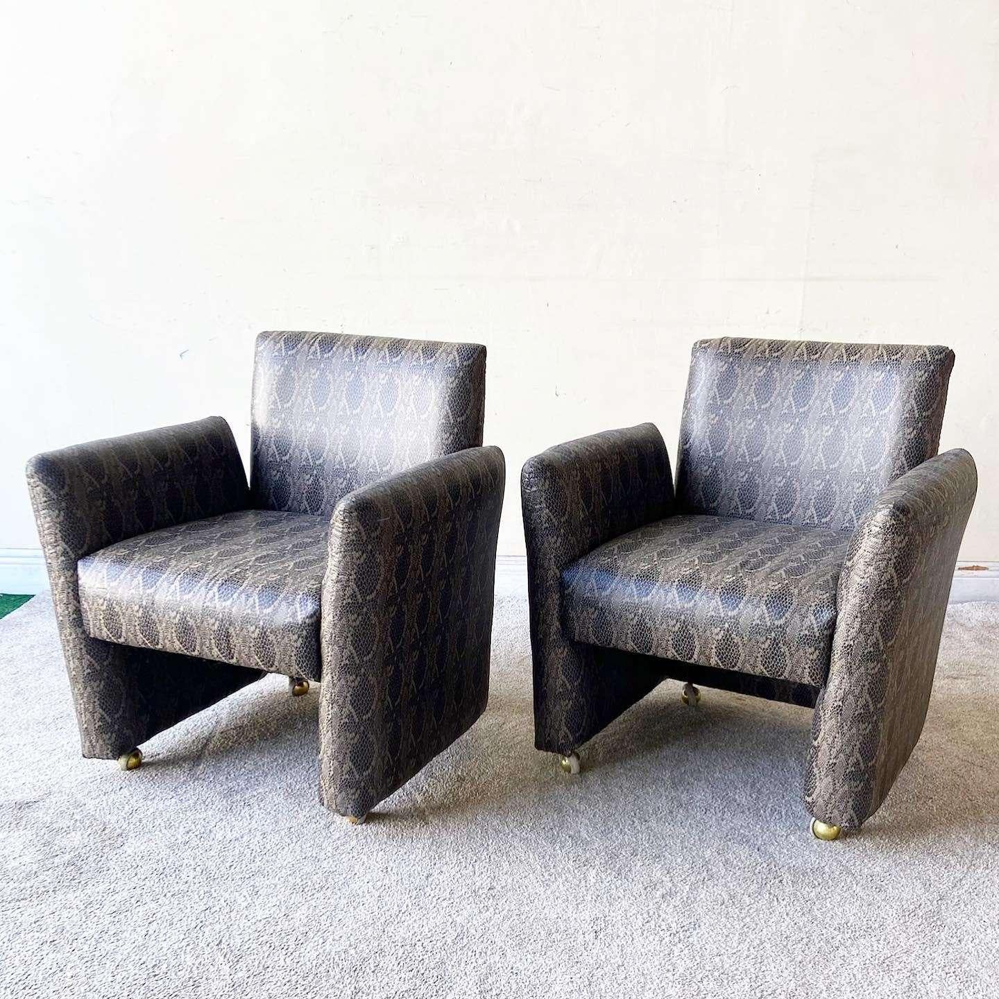 Exceptional pair of vintage postmodern “chiclet” chairs on wheels. Each feature a brilliant faux snake skins vinyl upholstery.

Seat height is 18.5 in

