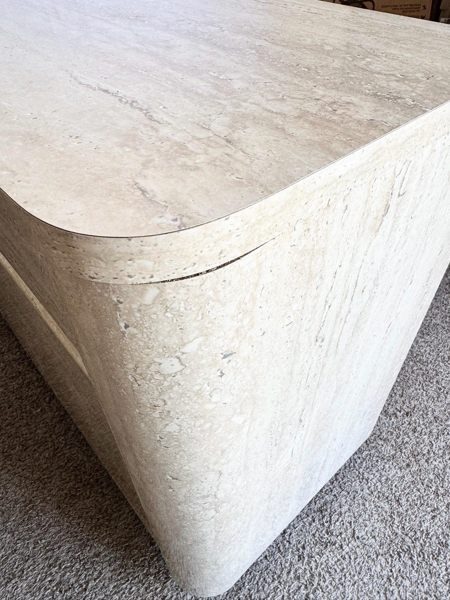 Postmodern Faux Travertine and Black Laminate Credenza pairs creamy surfacing with bold black accents, sculptural storage, and coastal-modern elegance.
 

 Some wear to the deface and one corner as shown in the photos. 
 

 We sell items as
