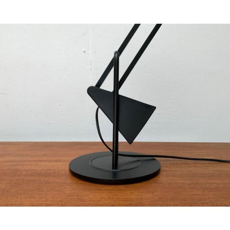 Filigree table lamp from Luxo after a design by Fridolin Naef from the early 80s.

The complex design of the flamingo with connected joints and the large counterweight enables very special flexibility. It is perfectly balanced and allows countless