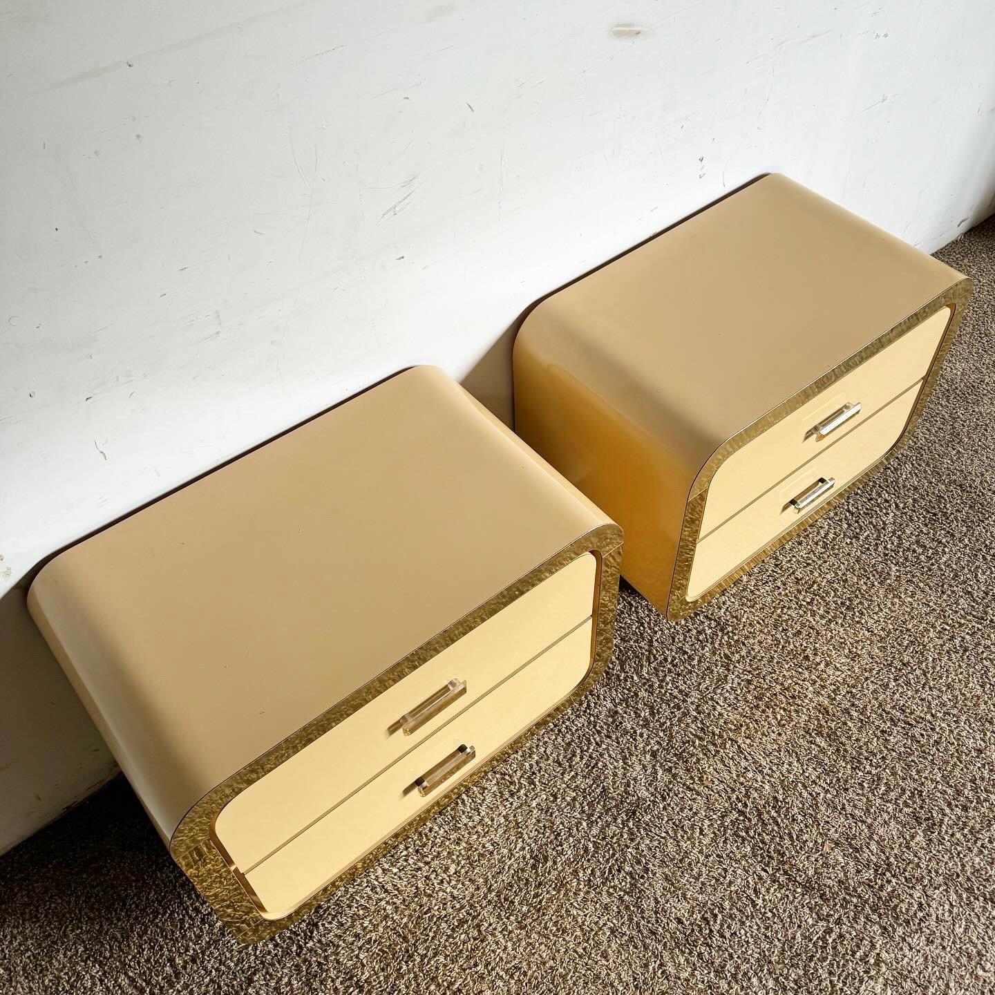 Elevate your bedroom's style with this pair of Postmodern Flesh Lacquer Laminate Waterfall Nightstands, featuring elegant gold accents. The warm, flesh-toned lacquer and sleek waterfall design offer a contemporary look, while the gold accents add