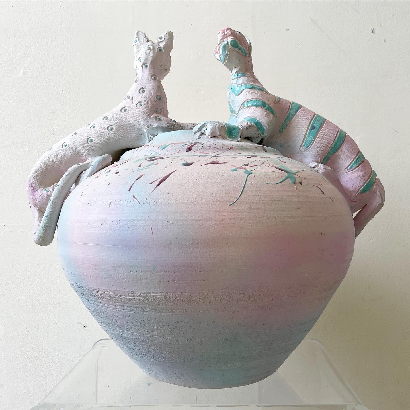 Amazing ginger jar shaped plaster vase. On top of the vase is an abstract colorful leopard and Tiger. Psychedelic shades of green pink and purple cover the vase and strip and dot the cats.
 