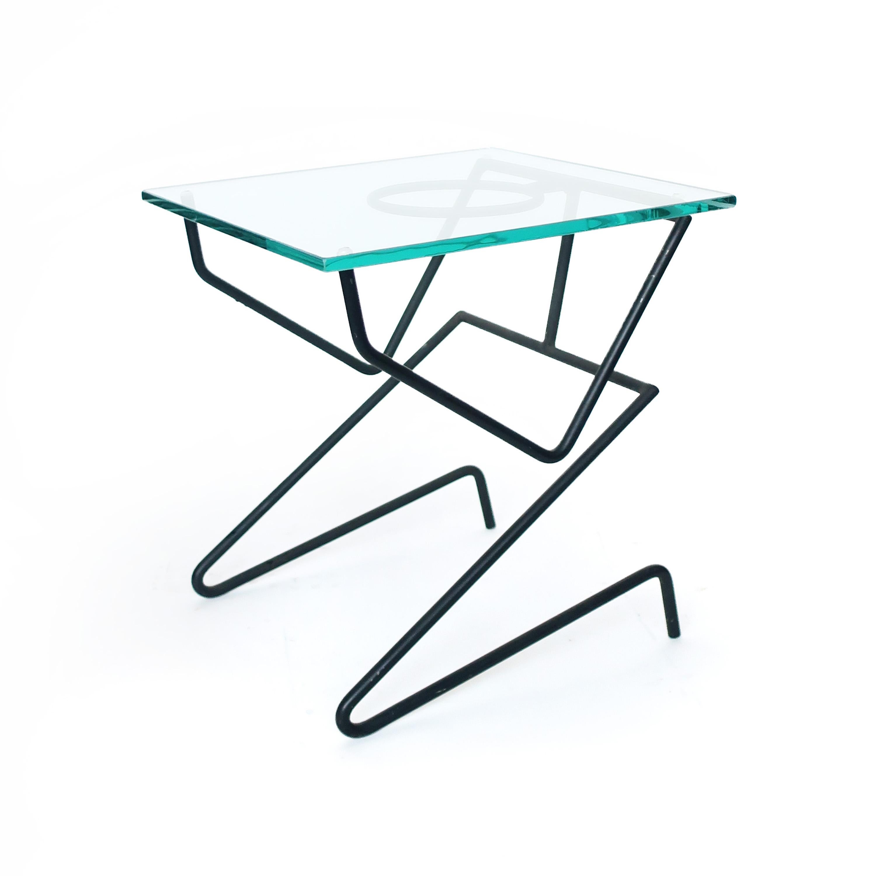 An unusual vintage figural side table by an unknown designer. With an iron base and thick glass top, this 
