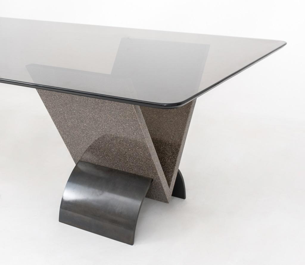 Postmodern design smoked glass dining table on base made of two grey granite and steel pedestals, the rounded rectangular glass top with molded edge, above two pedestals, each comprising a V-form granite support on steel arches.

Dimensions: 29