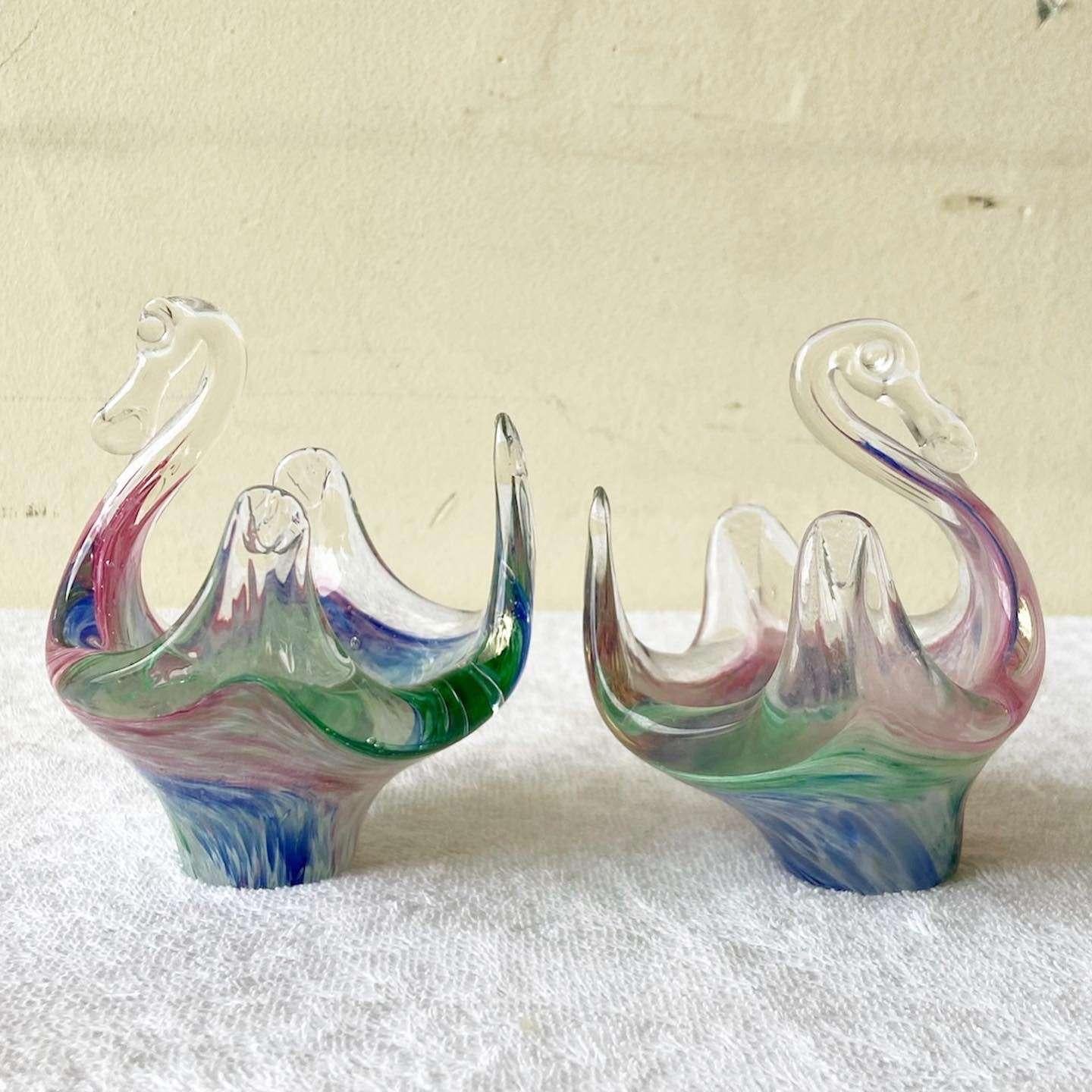 Amazing pair of hand blown glass seams. Each feature a green, pink and blue interior.
