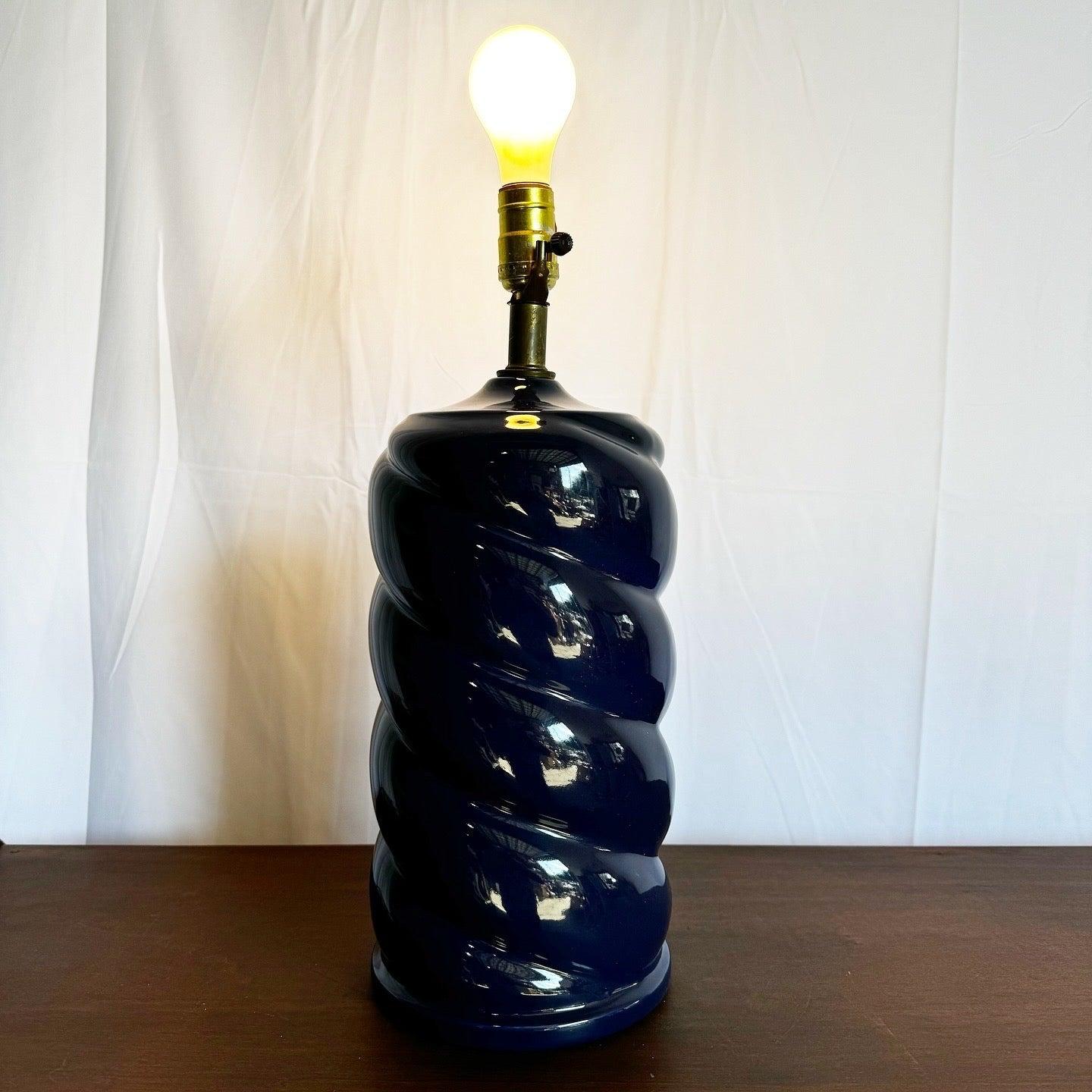 Add a touch of postmodern sophistication to your space with this stunning glossy blue swirl lamp, featuring a bold sculptural design.
 
 We sell items as acquired, without restoring or repairing. Vintage pieces may have age-related wear. Review