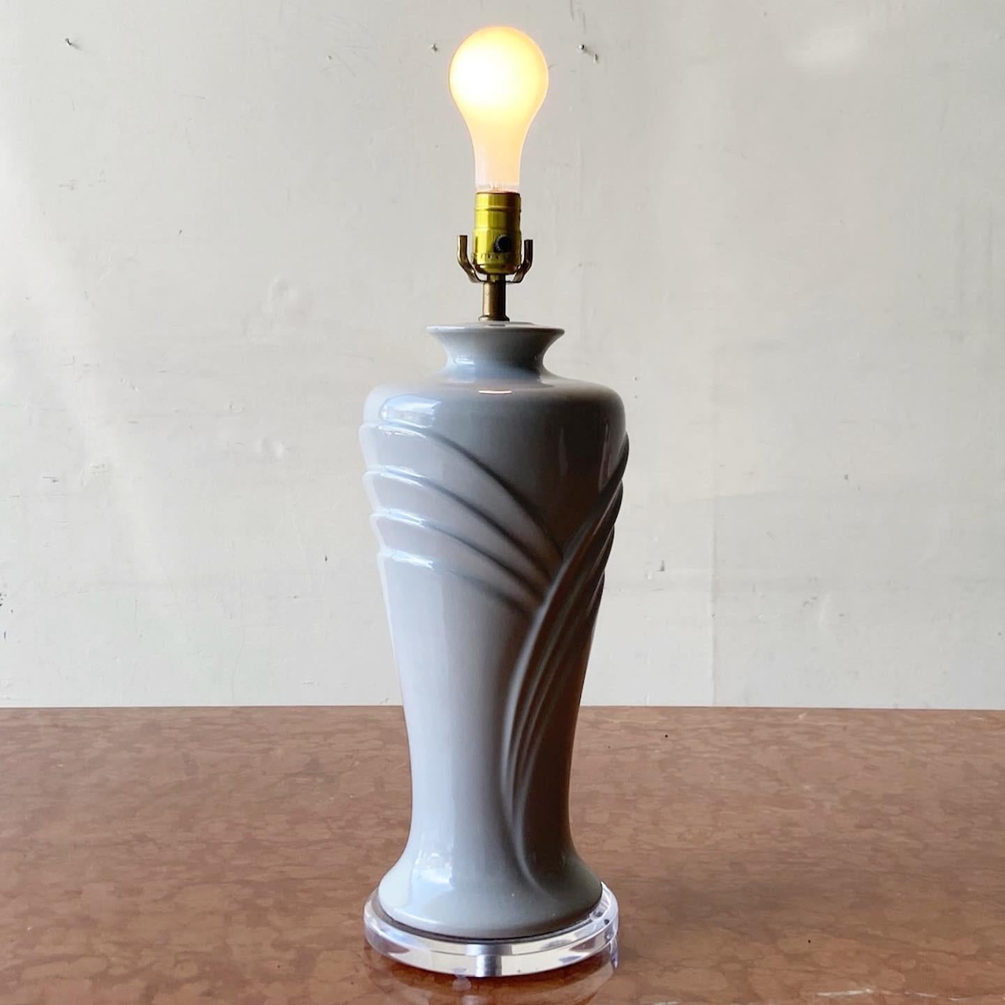 Amazing postmodern ceramic table lamp. Features a lucite base and grey glossy finish.

3 Way lighting.