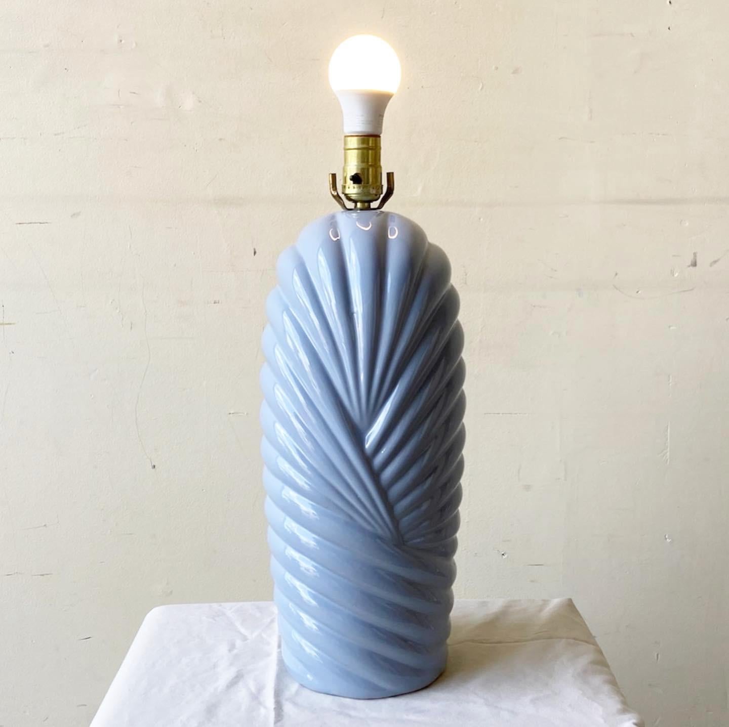 Incredible postmodern ceramic table lamp. Features a sculpted body with a gray gloss finish.

Additional information:
Material: Ceramic
Color: Gray
Style: Postmodern
Time Period: 1980s
Dimension: 7