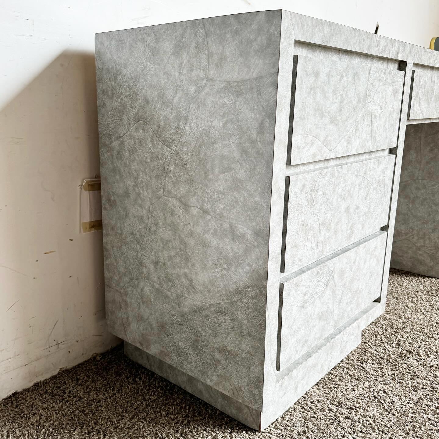Améliorez votre espace de travail avec le bureau Postmodern Gray Faux Stone Laminate, doté de quatre tiroirs pour une organisation optimale. Ce bureau associe un stratifié contemporain en fausse pierre à une teinte grise élégante, créant ainsi un