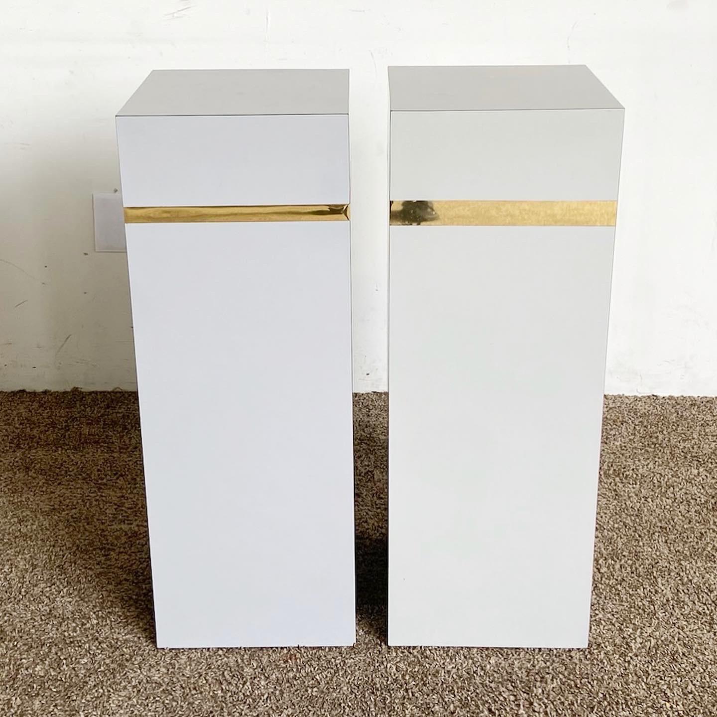 Enhance your home with our Postmodern Gray Lacquer Laminate and Gold Rectangular Pedestals, a pair that combines sleek design with bold gold accents.

Features sleek laminate surfaces in two subtly different shades of gray.
Gold accents add a touch
