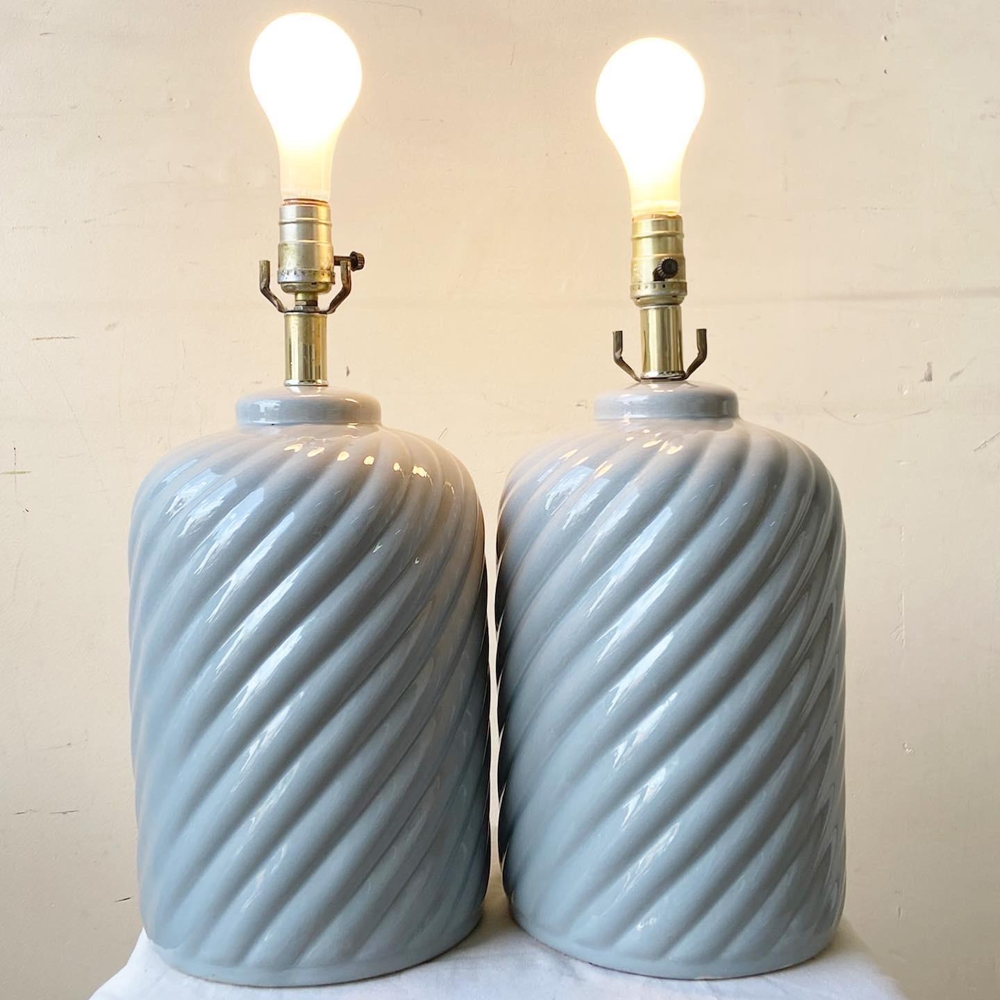 Exceptional pair of ceramic table lamps. Each feature a swirl design with a gray gloss finish.
 