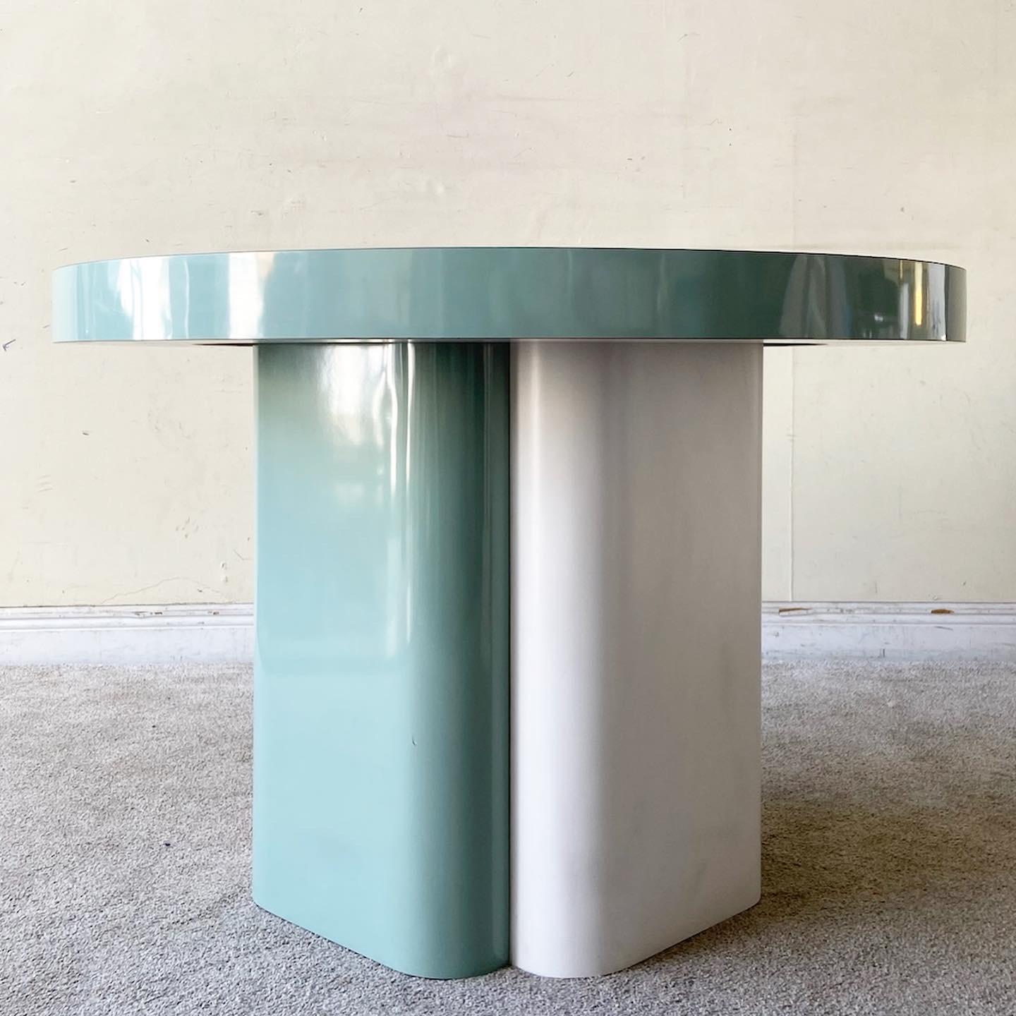 Incredible vintage Postmodern circular top dining table. Features a soft minty green and white lacquer laminate.
