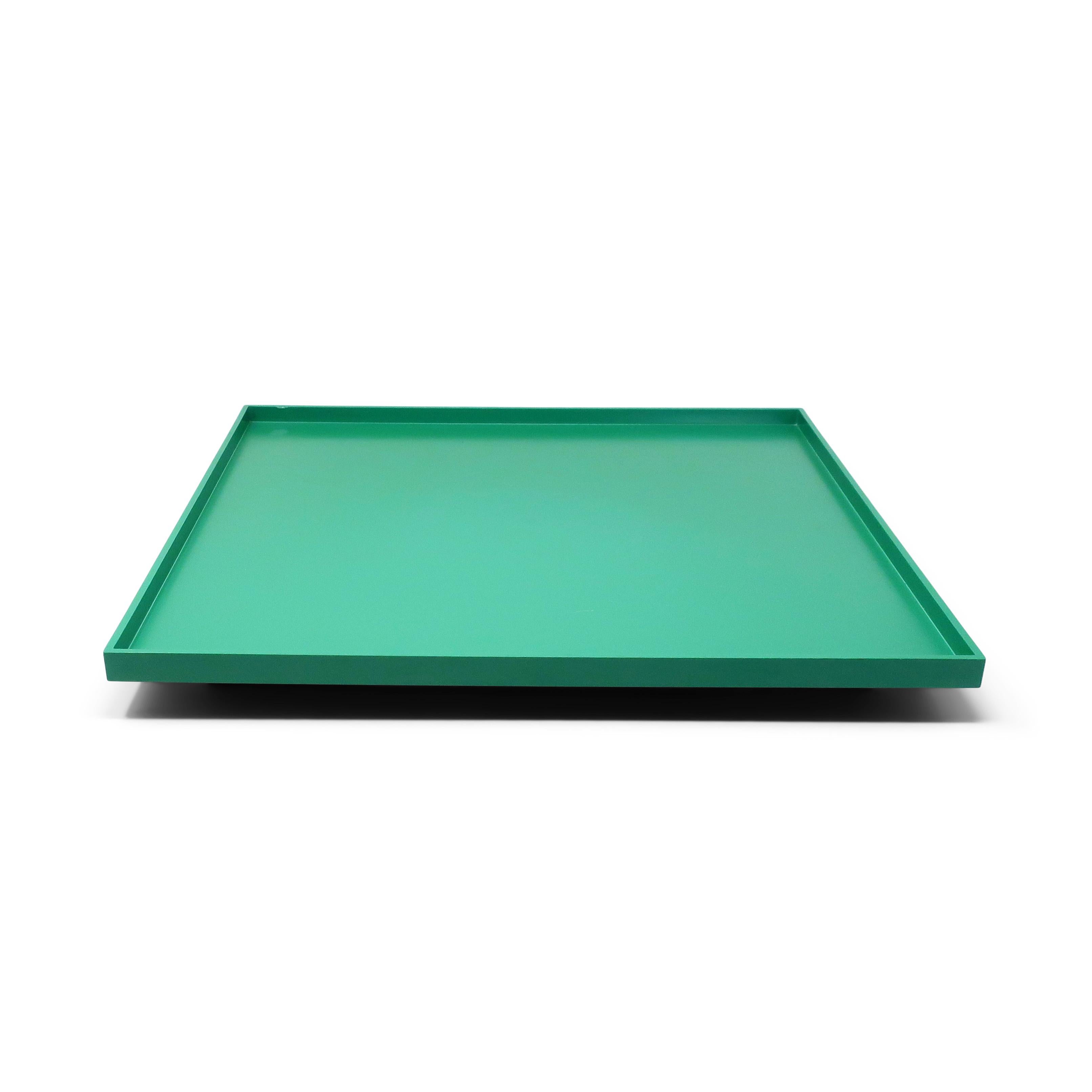 A classic design by Memphis Milano-affiliated American postmodern designer and architect Michael Graves for his Euclid line for Alessi, the Italian home goods powerhouse. A green square tray sitting on blue rectangular feet.  The Euclid line's