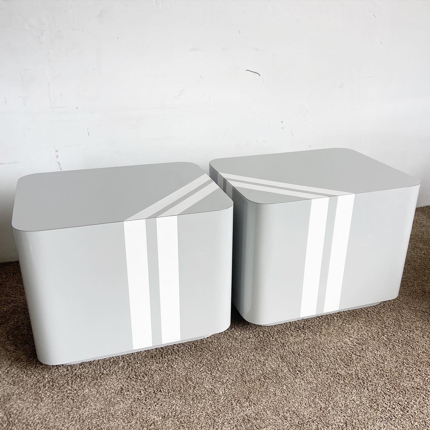 Discover contemporary flair with our Grey and White Striped Lacquer Laminate Side Tables, combining chic design with functionality for a unique aesthetic.

Striking grey and white striped design offers a visual pop.
Sleek lacquer finish for a