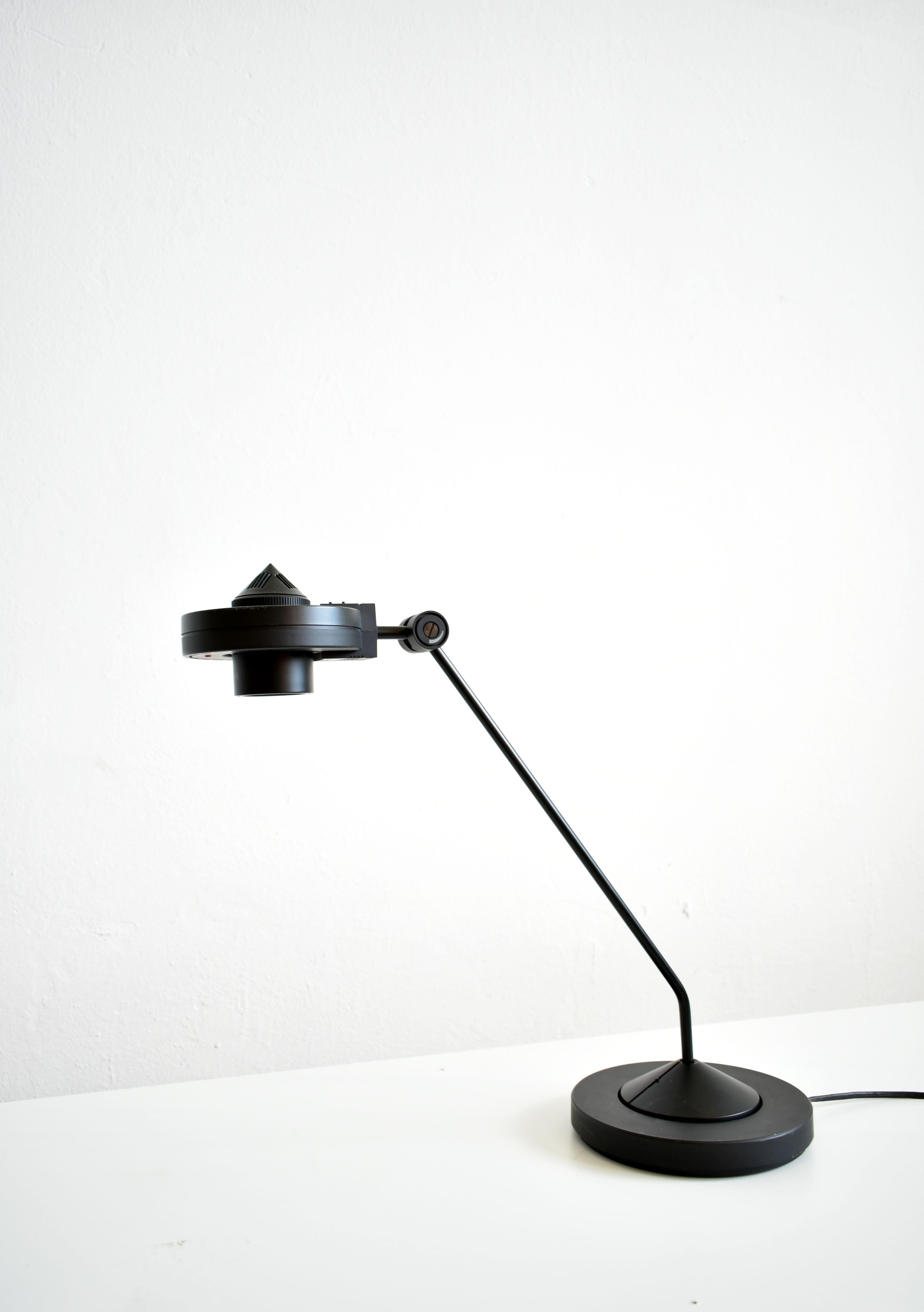 Black metal and plastic dimmable halogen desk lamp produced by German company Staff in 1980's

High-end design from the 1980s

The lamp was designed by German designer Hartmut S. Engel

Heavy base measures 20 cm in diameter, the adjustable