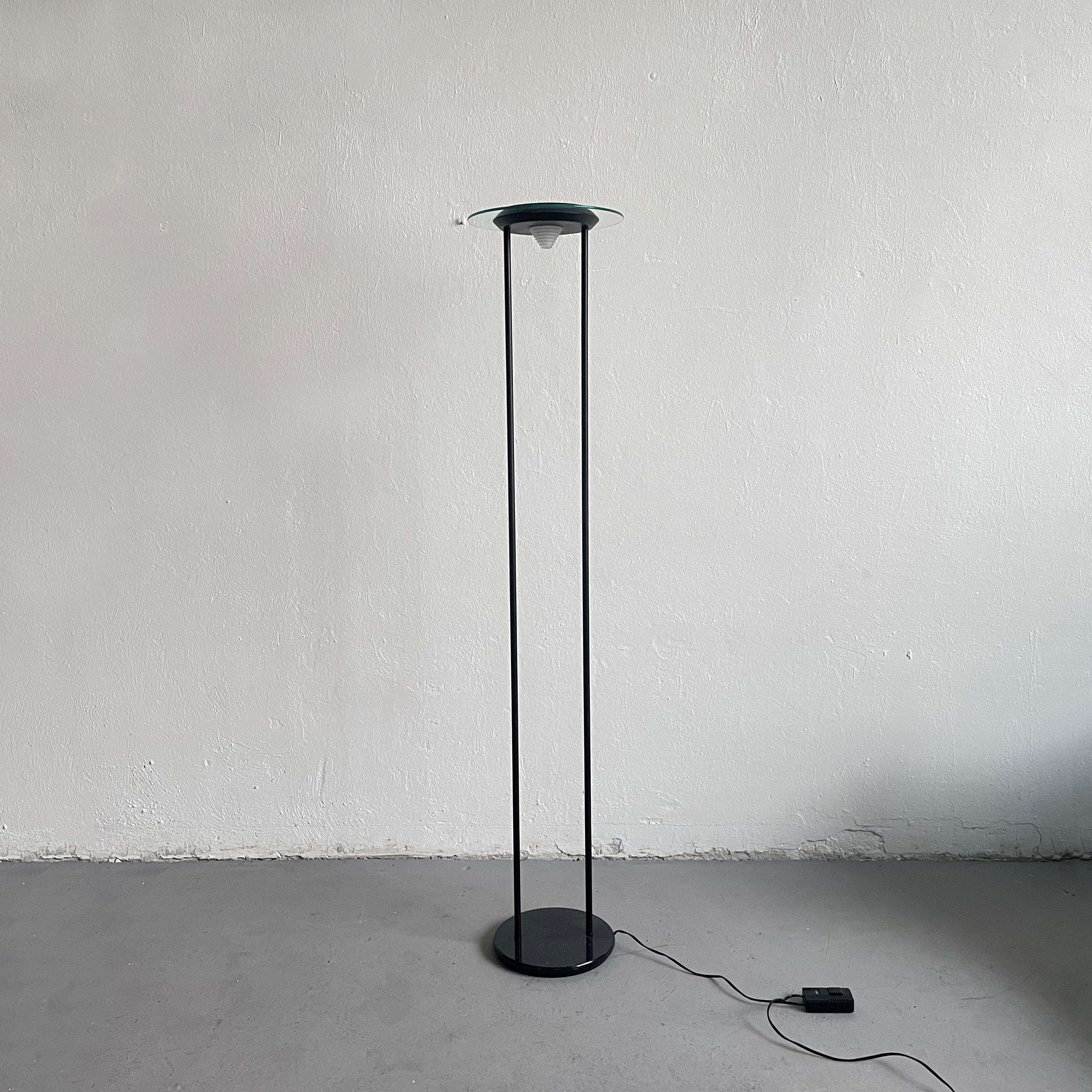 Vintage halogen floor lamp, postmodern design from the 1980s.

Black faux marble base and black lacquered metal structure supports glass and metal UFO shaped lampshade

Unknown manufacturer.

The lamp is in good condition and in a fully