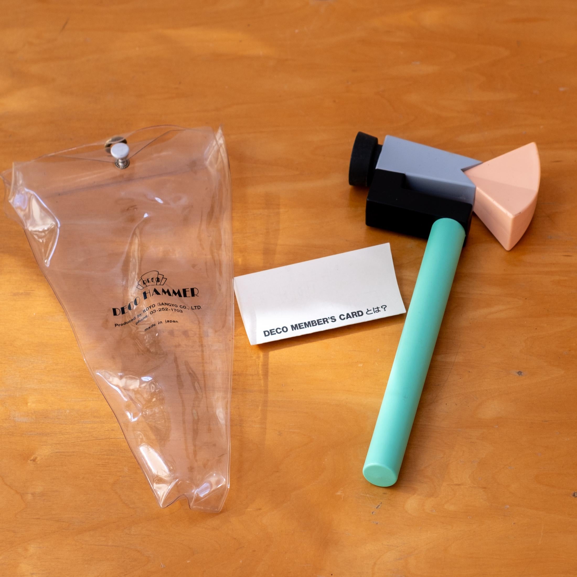 Hammer by Koyo Sangyo, with the original  packaging. Memphis-inspired hammer in shades of pale green, pink, gray, black and yellow. It comes in the original plastic sleeve and card. Japan, 1982.
