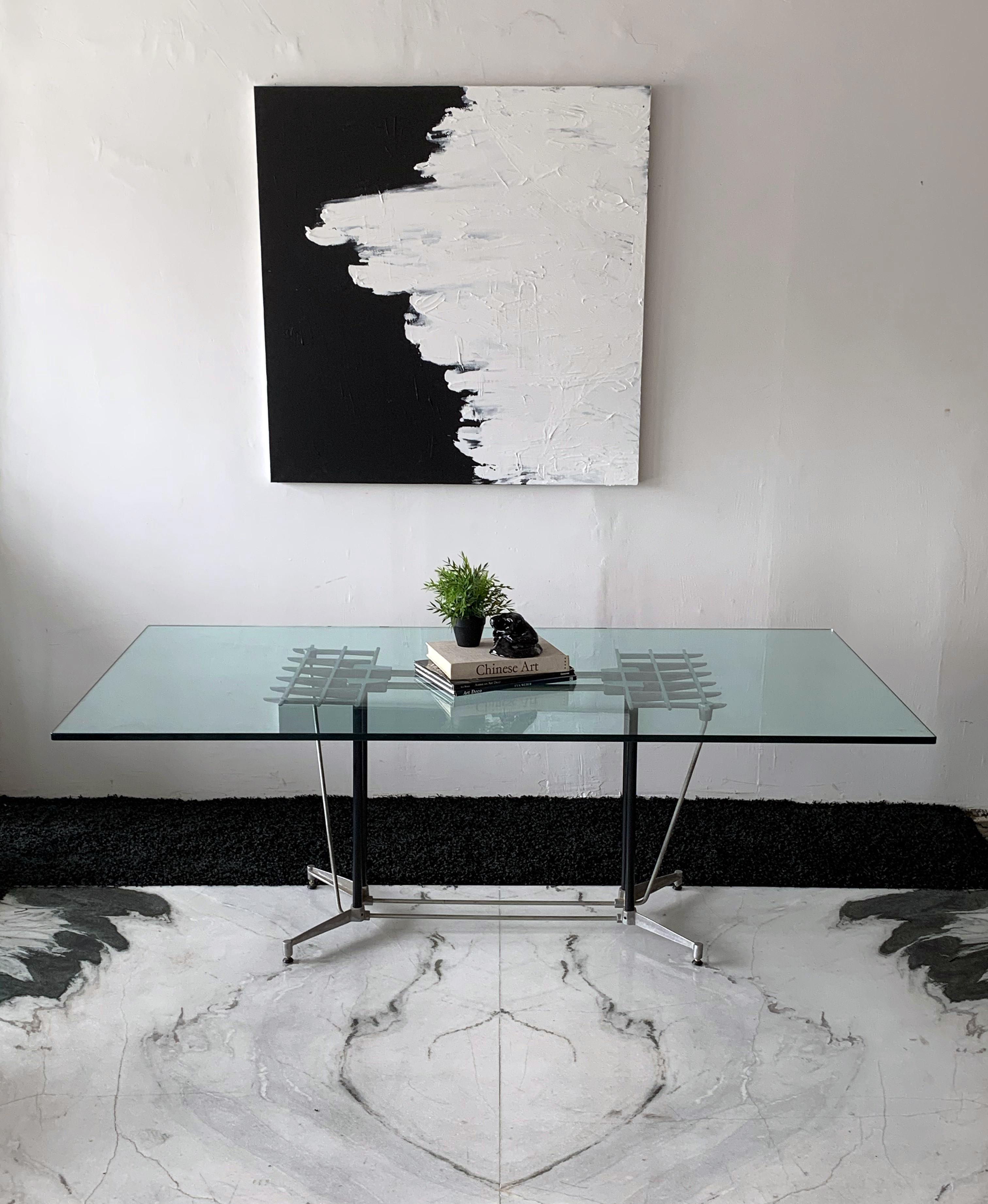 This dining table is equal parts post modern and industrial modern and just oozes California modernism. This dining table or writing desk was designed by Robert Josten in the 1970's. Made of aluminum, this metal grille / grid style is a staple of