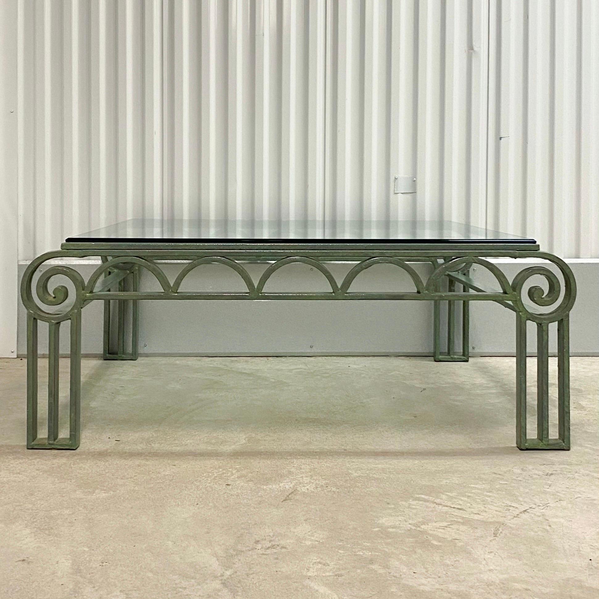 Vintage circa 1990s iron table with verdigris finish. Green painted iron with column legs meeting scrolled corners and half moon apron. Glass top. Available matching side table available separately as seen in last image.