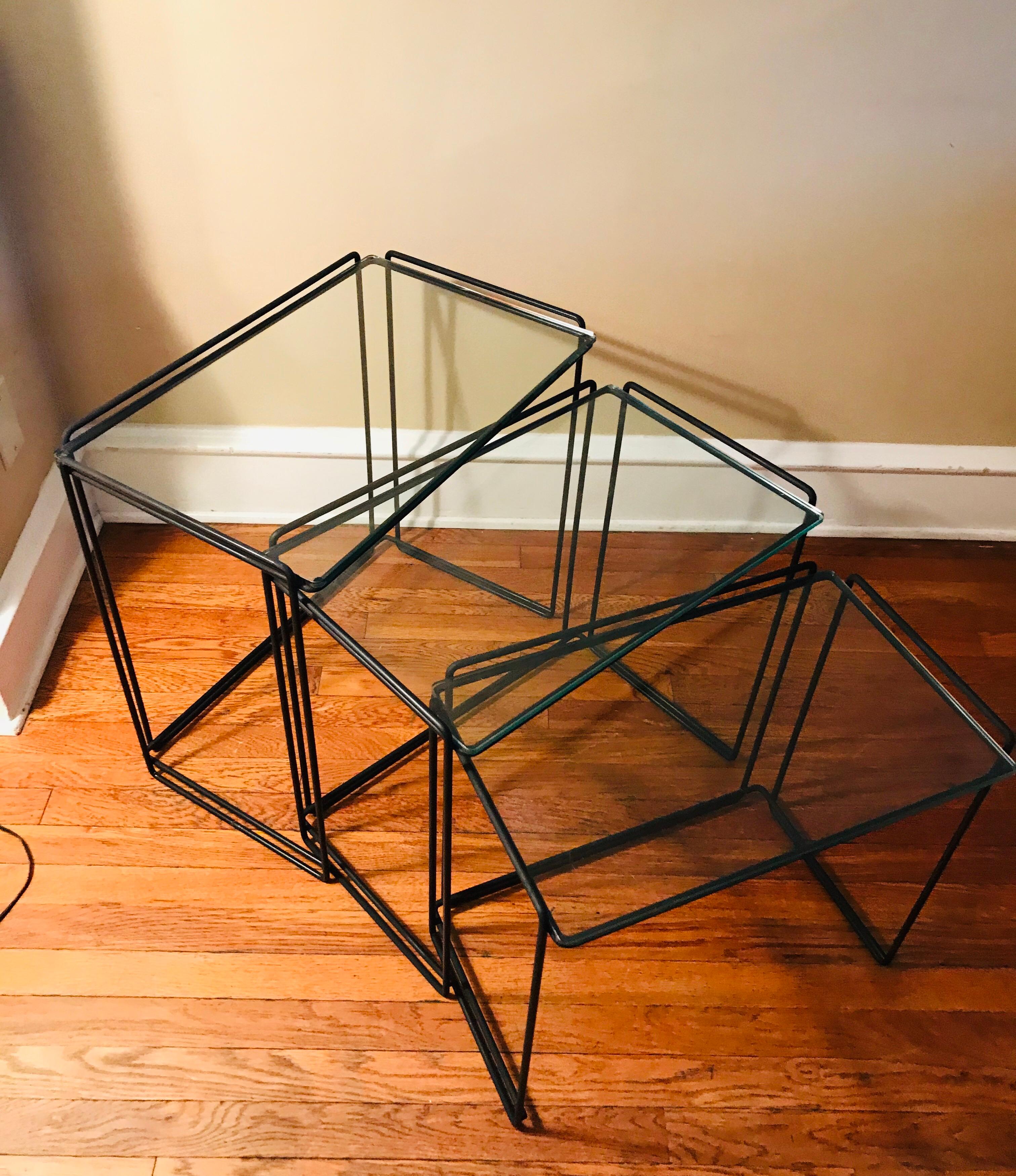 Pair of Minimalist cocktail side tables designed by French designer Max Sauze. 

Manufactured for Attrow, circa 1960s. 

Simple design with welded black wrought iron and glass. 

I would say this is an early example of Post-modernism, despite
