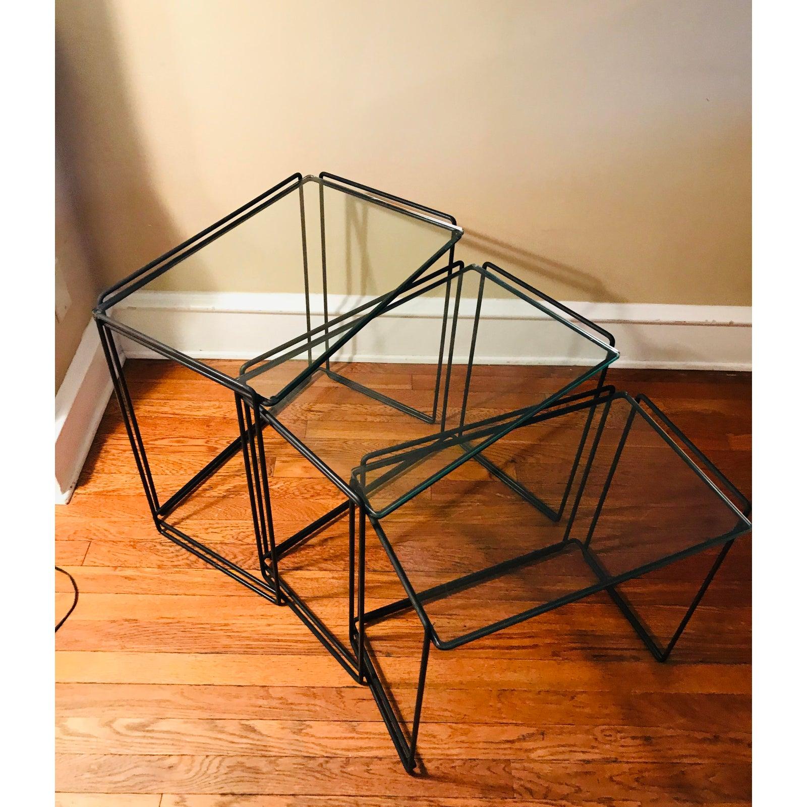 Set of Minimalist nesting tables designed by French designer Max Sauze. 

Manufactured for Attrow, circa 1960s. 

Simple design with welded black wrought iron and glass. 

I would say this is an early example of Post-modernism, despite being
