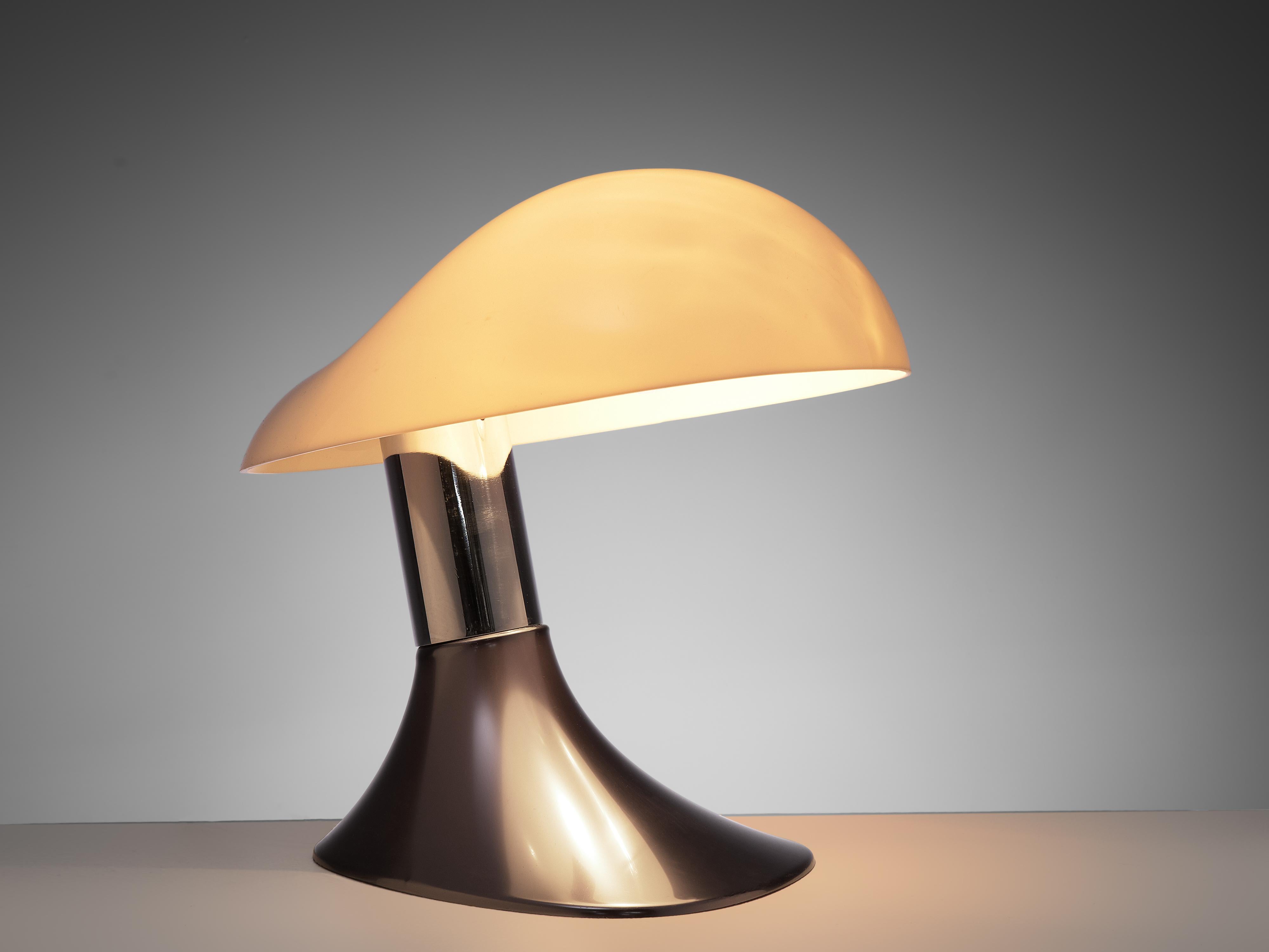 Guzzini, table lamp, metal, plastic, Italy, 1970s.

A Postmodern table lamp from Italy that features a dark foot and tilted metal base and a big shape on top. This shape of the lamp makes it a true eyecatcher even when not in use and gives it an
